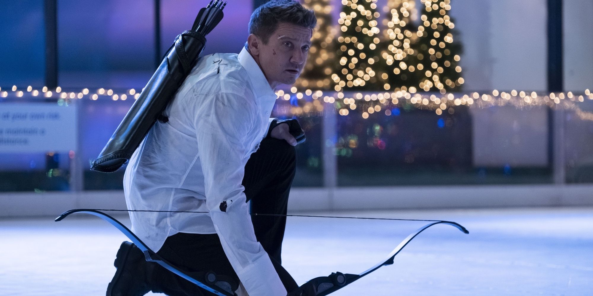 Hawkeye kneeling on an ice ring while looking to the distance in the show Hawkeye.