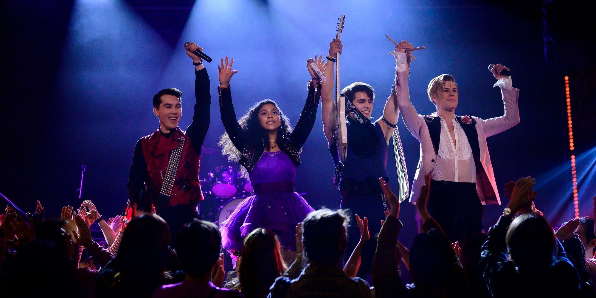 A group of teenagers celebrating on stage in the show Julie and the Phantoms.