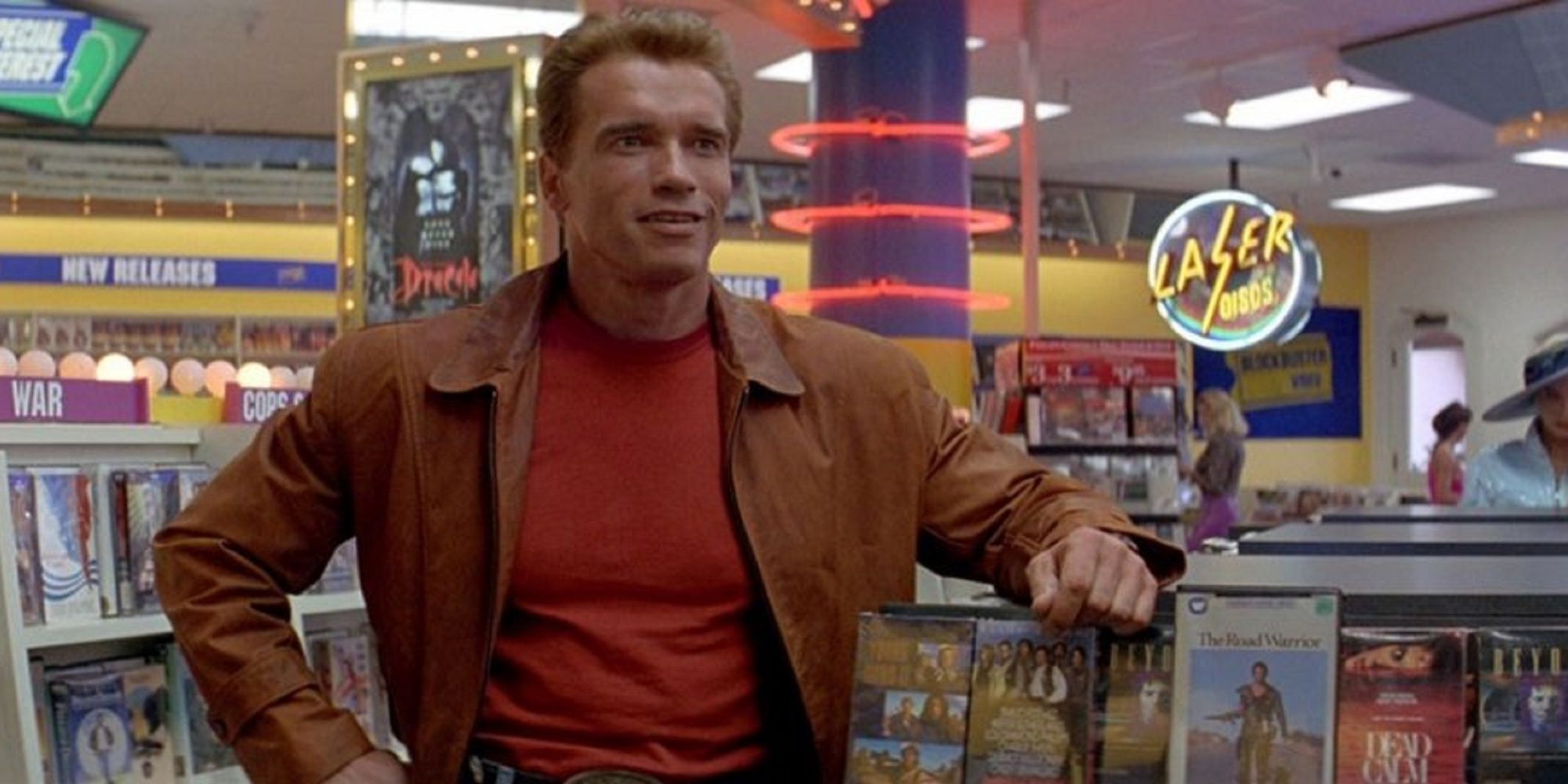 Jack Slater standing near his fake 'Terminator 2' poster in 'Last Action Hero'.