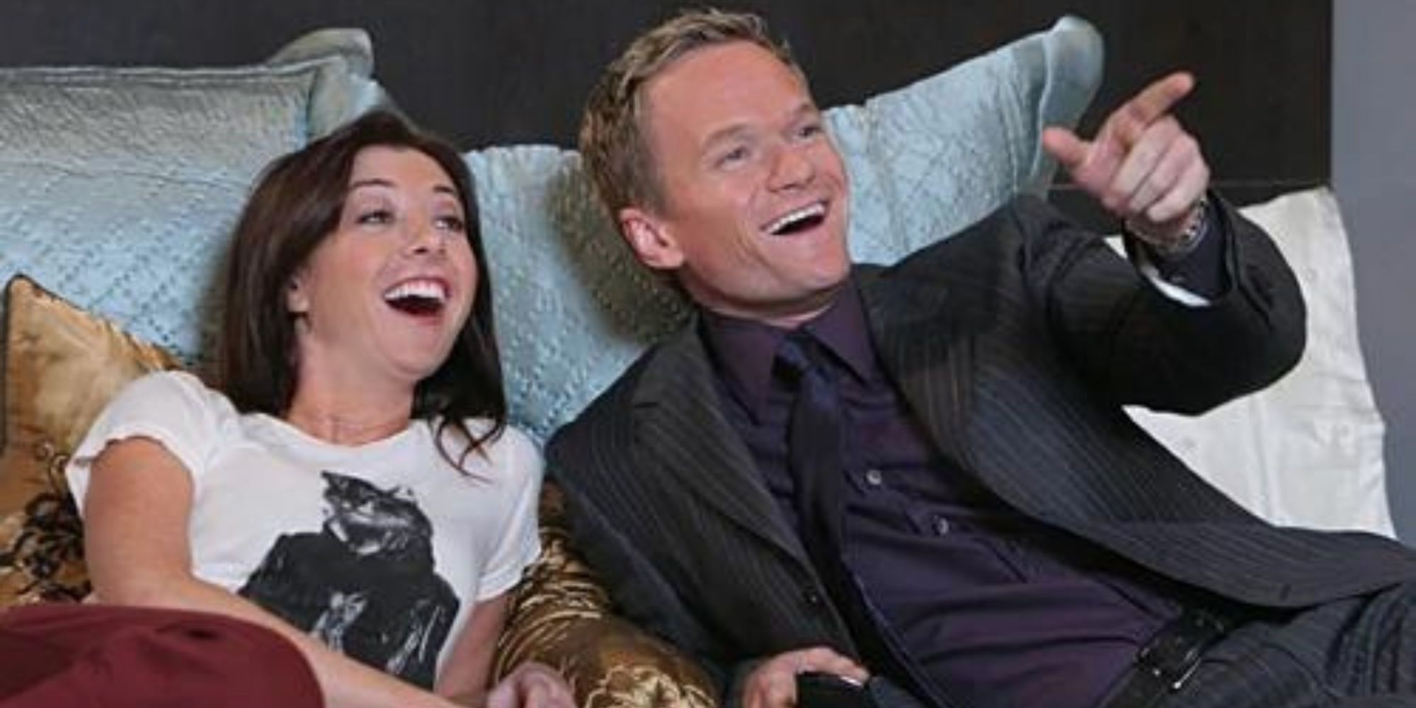 Lily and Barney from How I Met Your Mother lying on the bed together