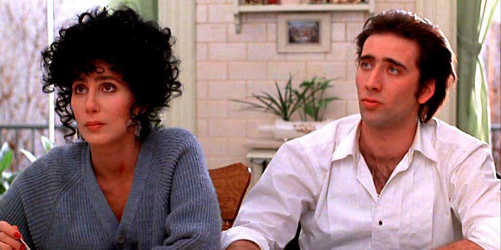 Cher and Nicolas Cage from Moonstruck sitting together
