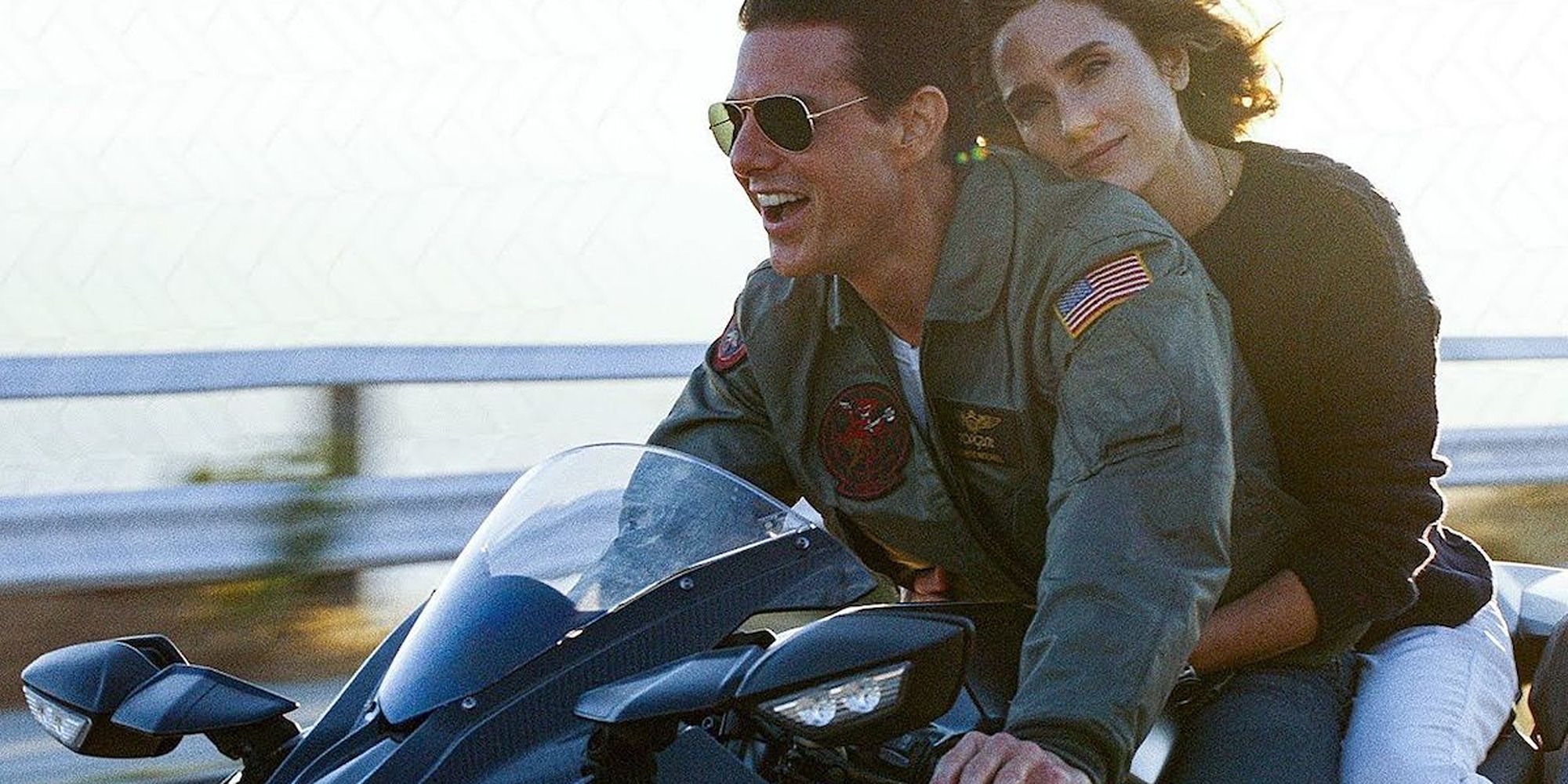 Maverick and Penny riding a motorcycle in Top Gun: Maverick