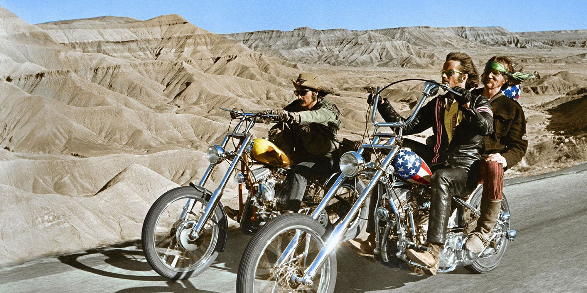 A man riding a motorcycle from Easy Rider down a highway in South America