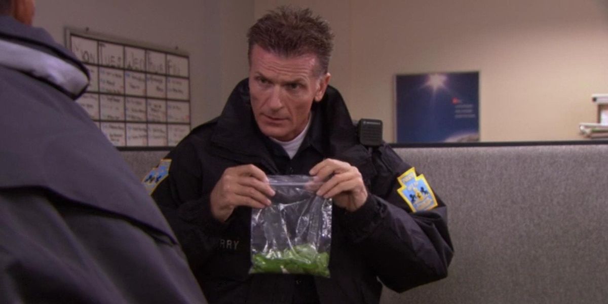 Michael Frames Toby With Basil, Police officer holding the bag of basil in the office
