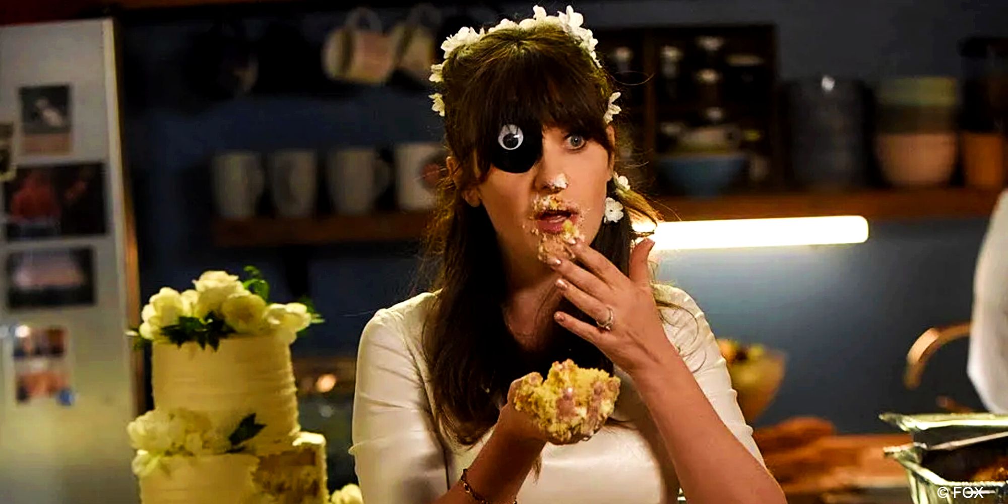 New Girl_Jess wears an eye patch while smearing cake on her face