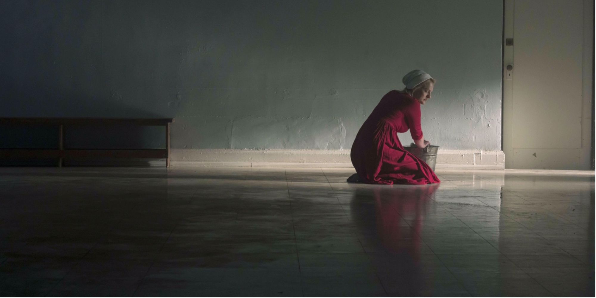 June crouched over a floor, cleaning