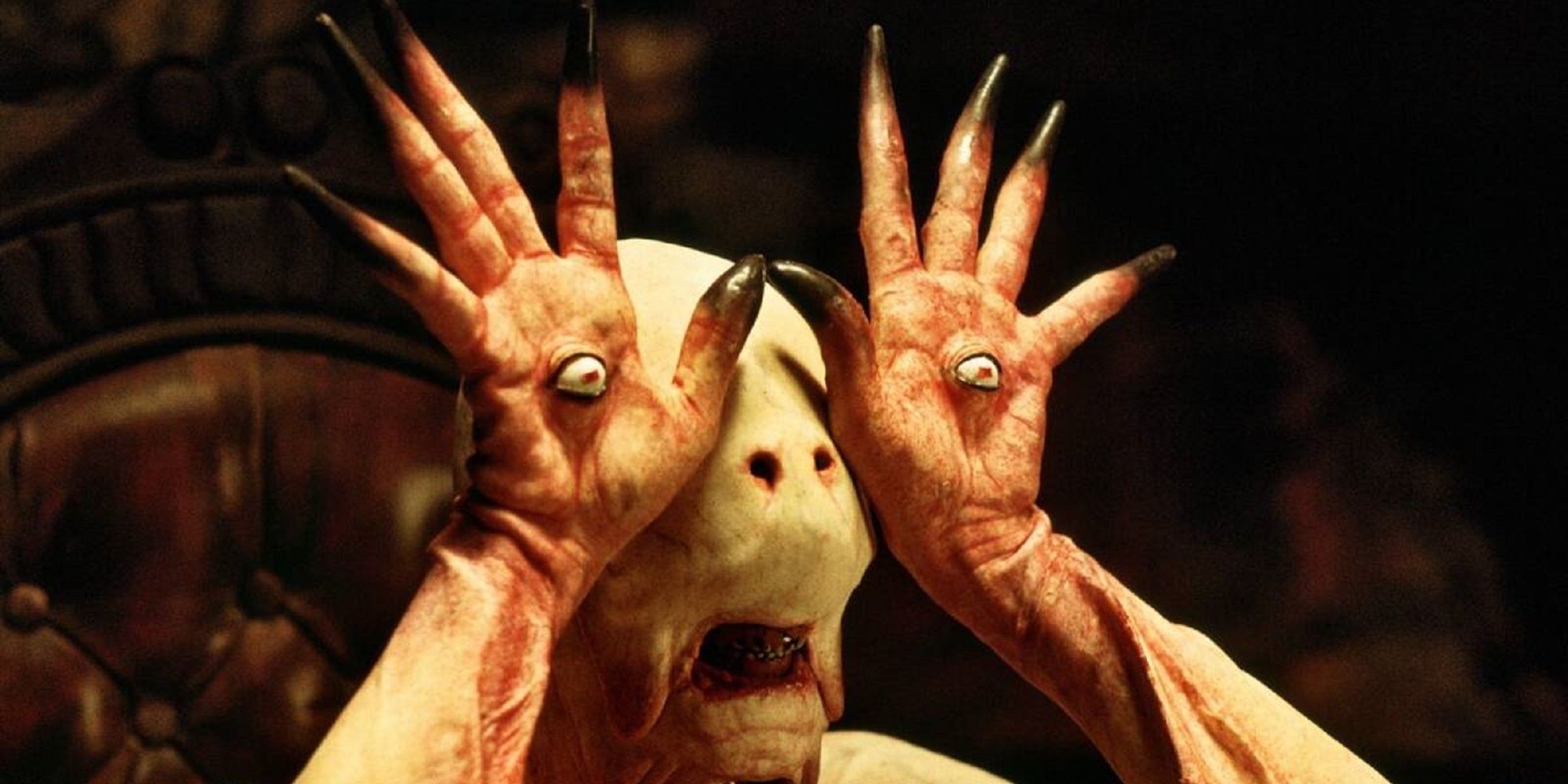 Pale man showing off eyeball on palm in Pan's Labyrinth
