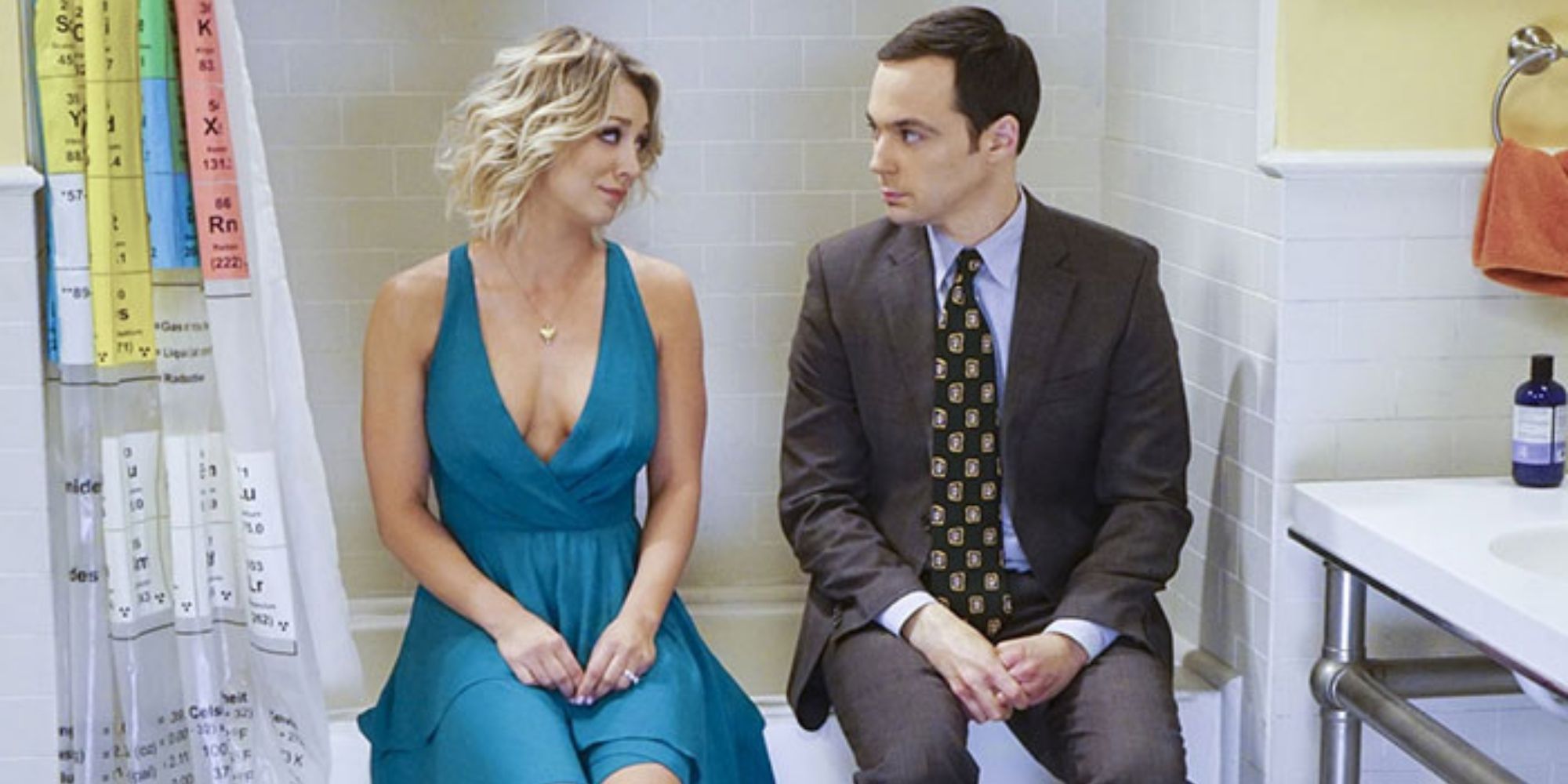 Penny And Sheldon from The Big Bang Theory sitting in Sheldon's bathroom