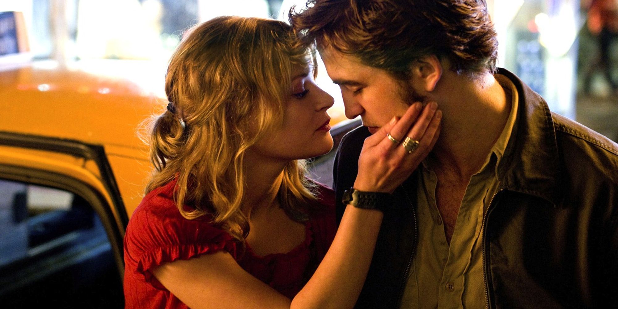 Robert Pattinson and Emilie de Ravin embracing in Remember Me