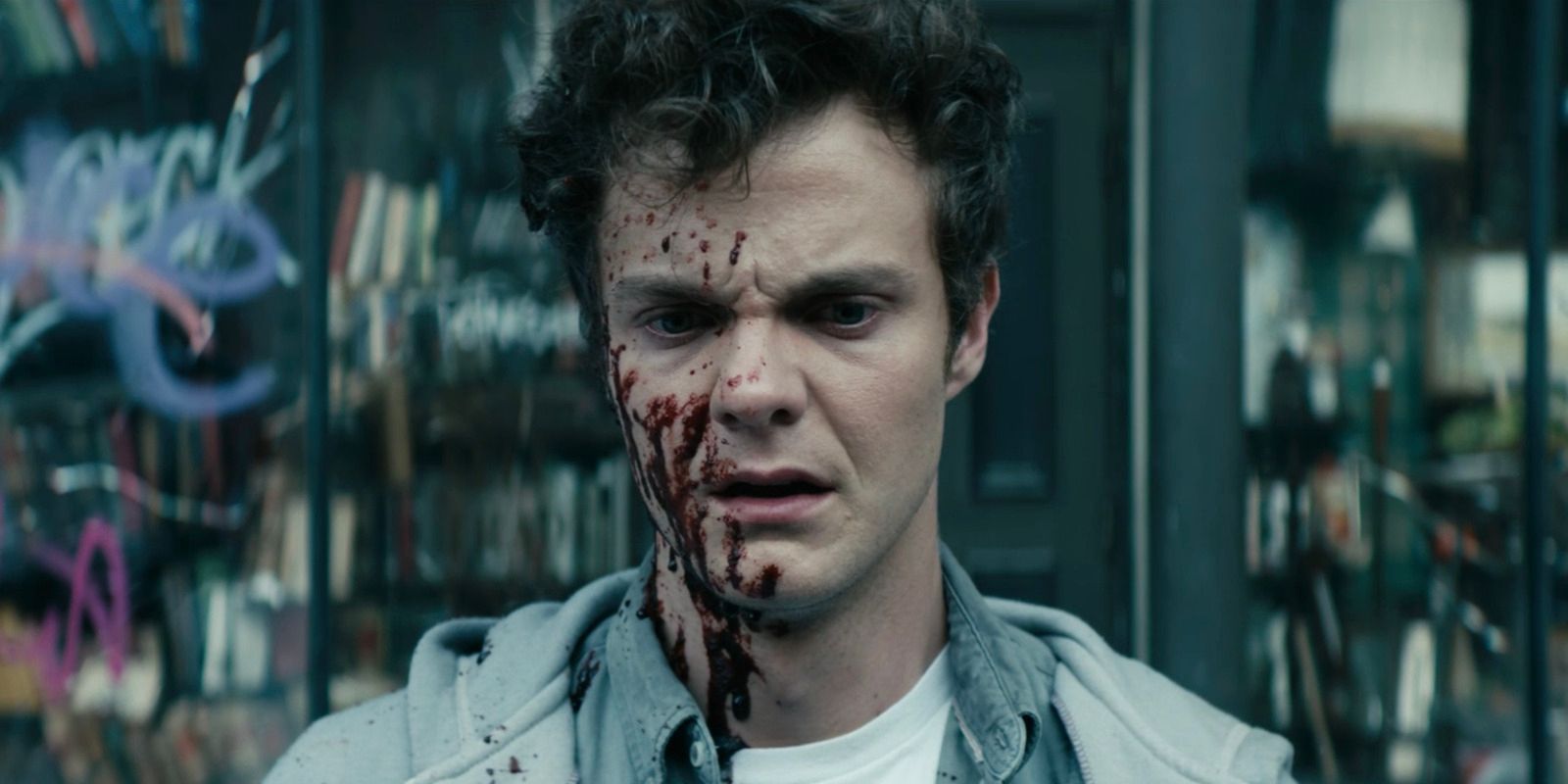 Jack Quaid as Hughie Campbell looking confused and upset with blood on his face in The Boys