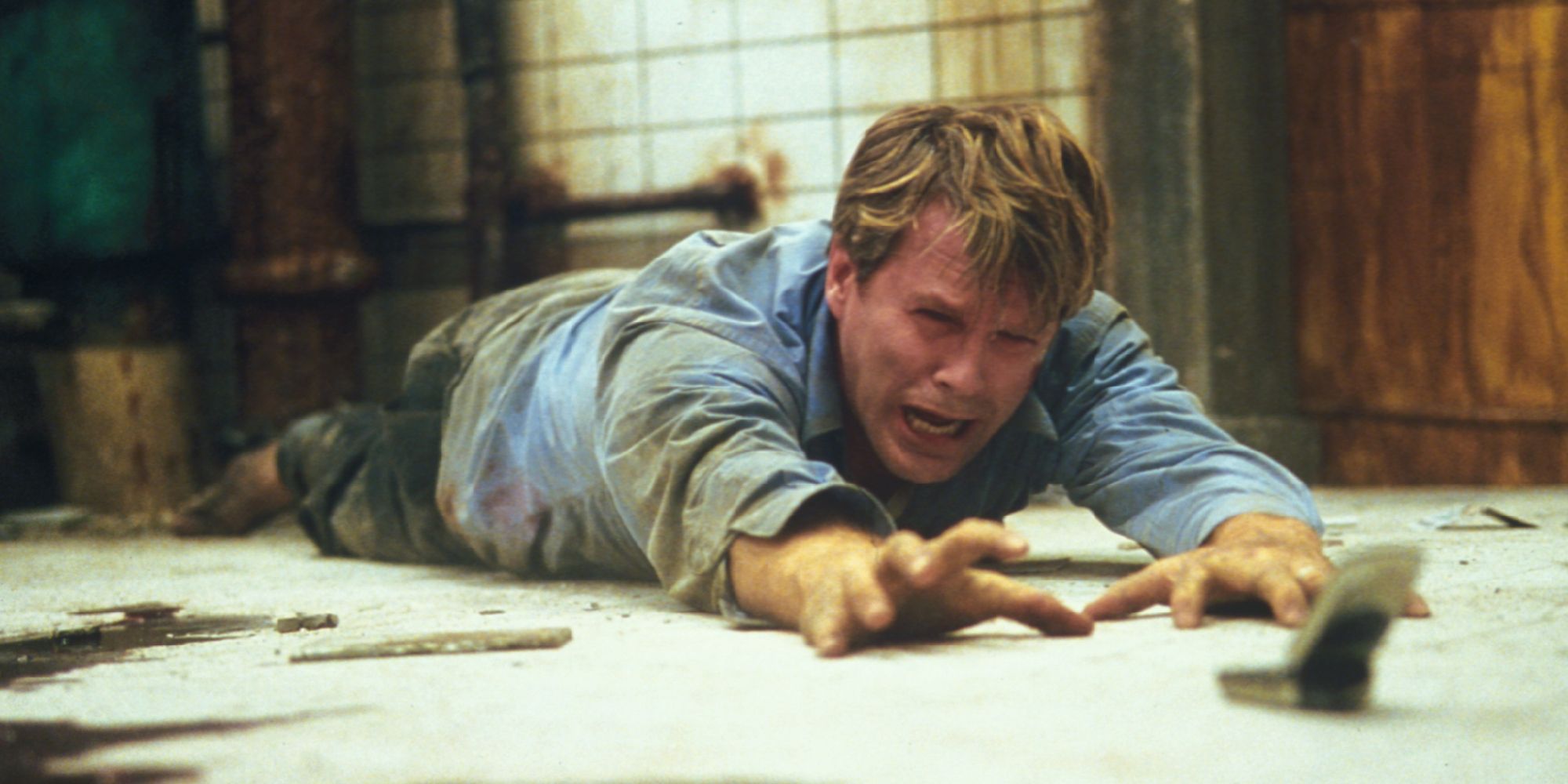 Cary Elwes reaching for keys in Saw