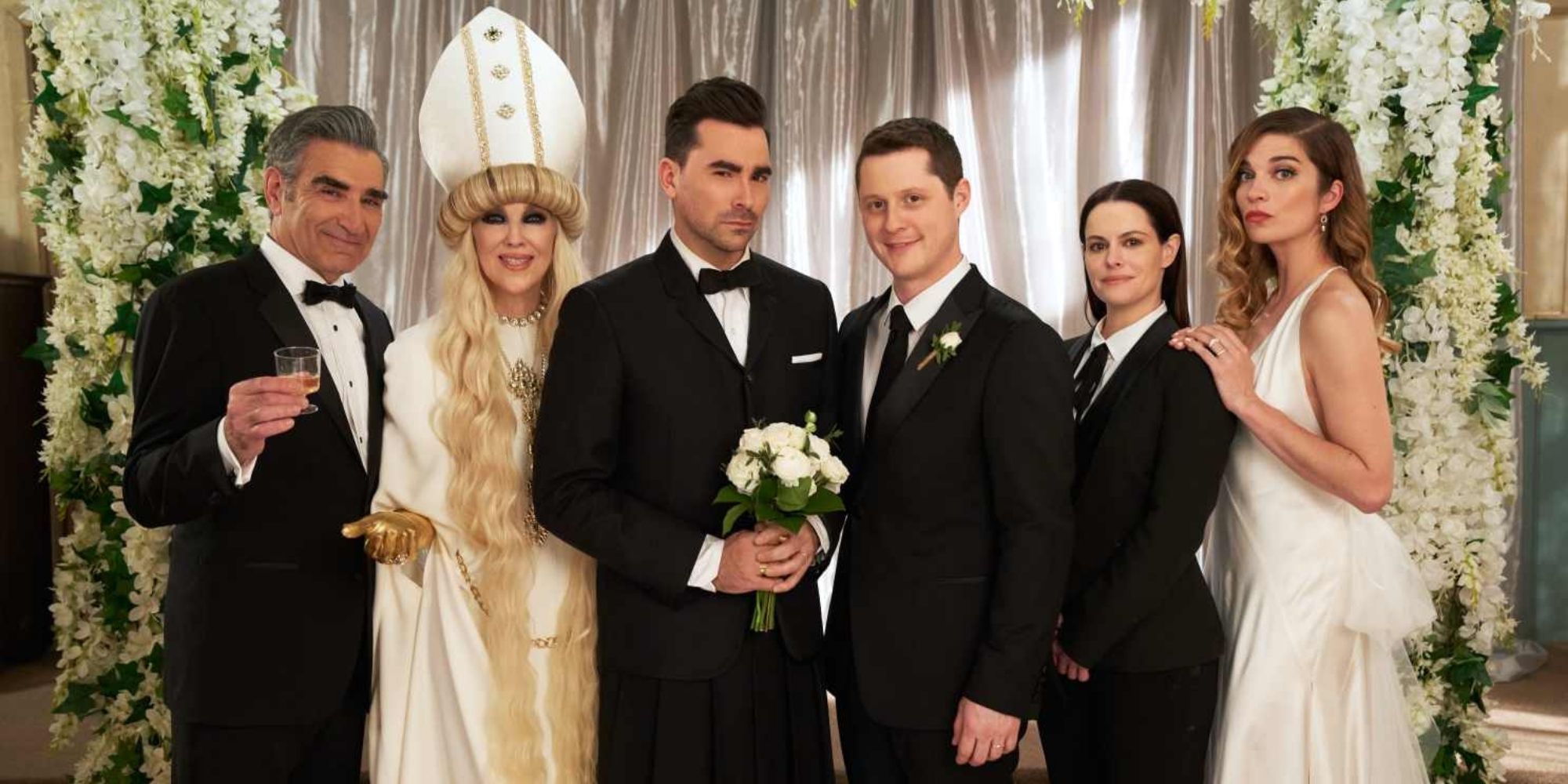 The Rose family and Stevie posing together at David and Patrick's wedding in Schitt's Creek.