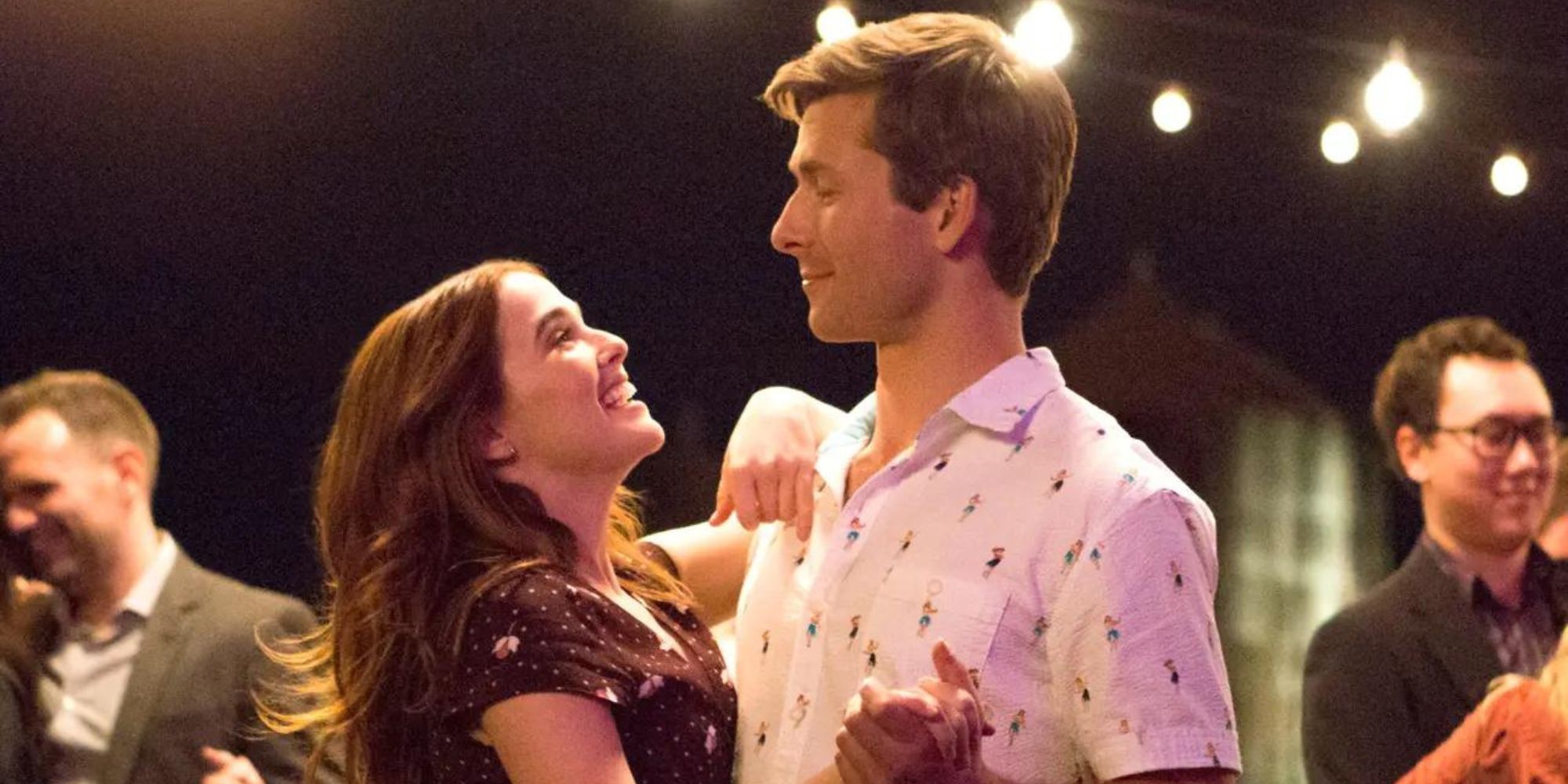 Zoey Deutch and Glen Powell as Harper and Charlie slow dancing in Set It Up