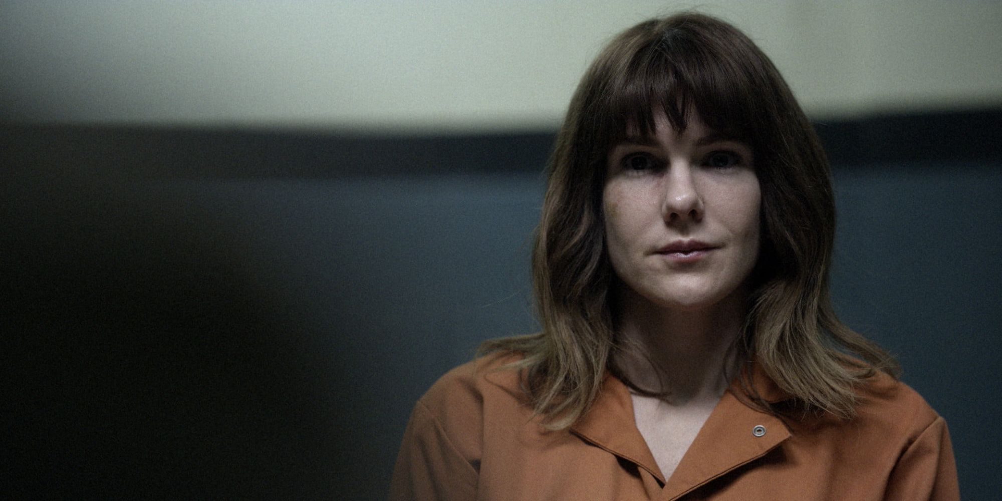 A female inmate looks smirky