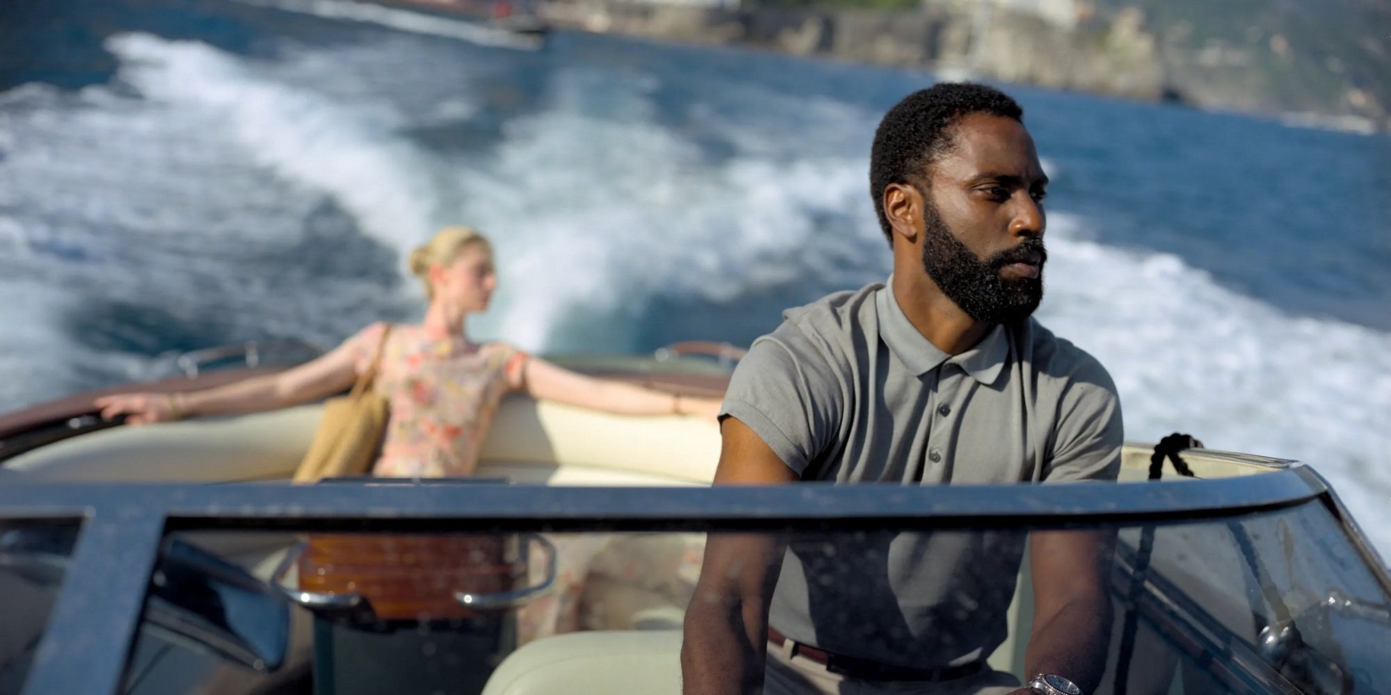 John David Washington as Protagonist driving a boat in Tenet.