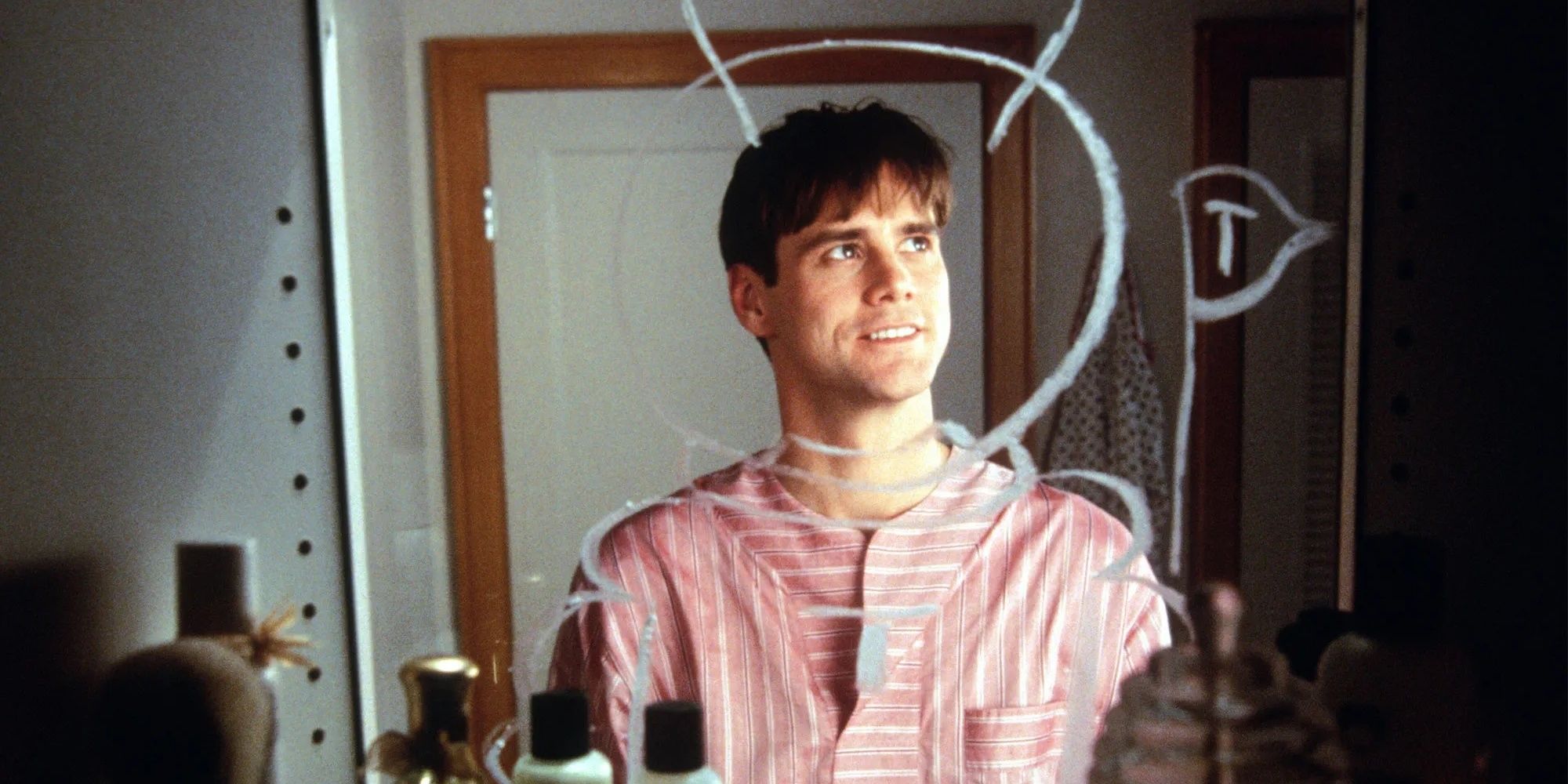 Jim Carrey looking into his mirror in The Truman Show.