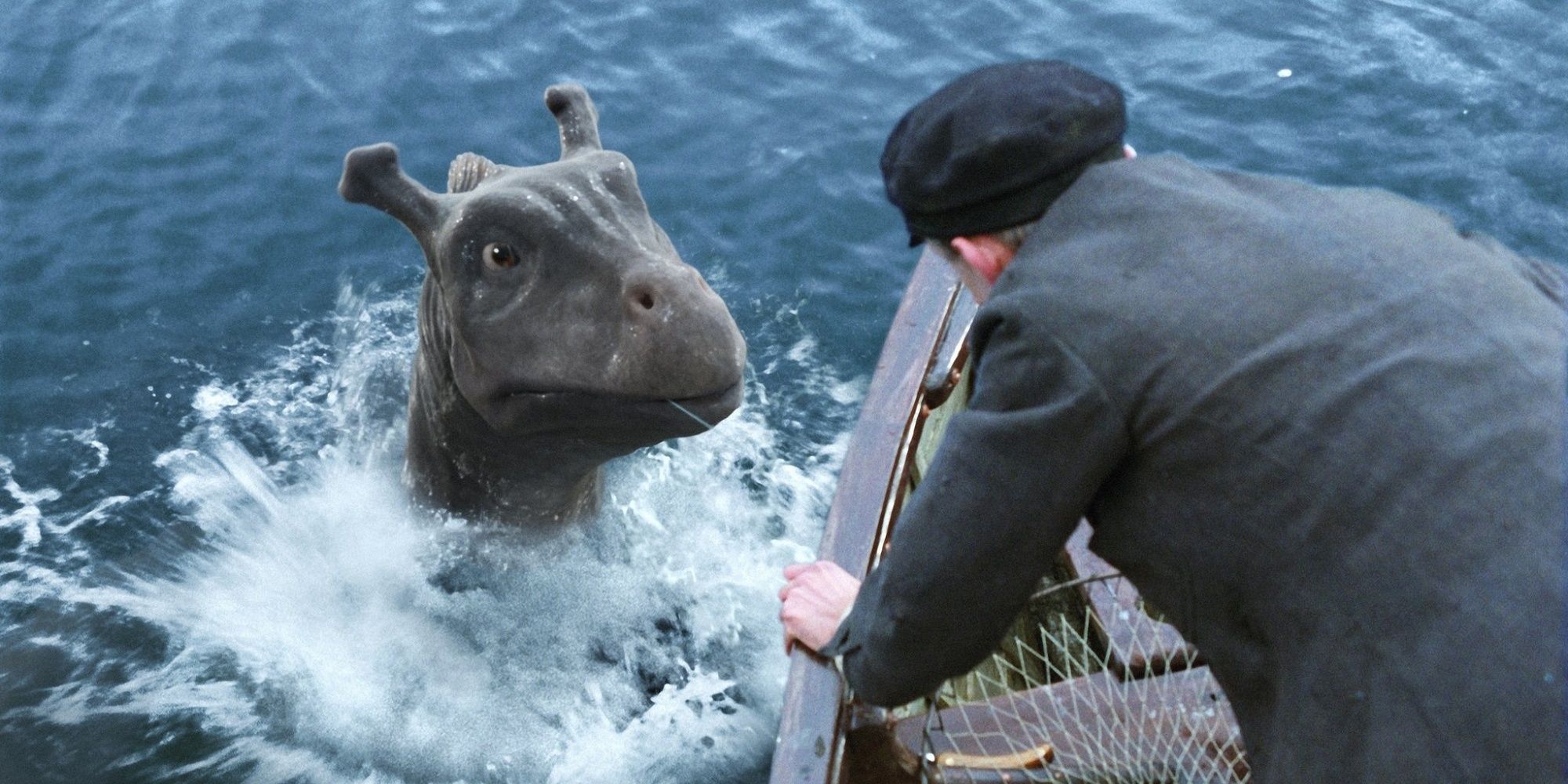 Crusoe and Angus in the water on a boat in The Water Horse.
