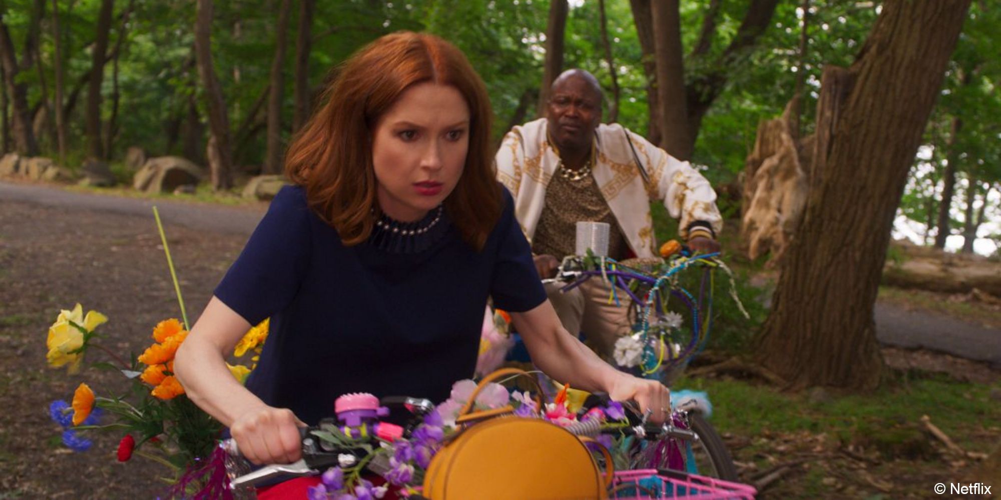 Unbreakable Kimmy Schmidt_Kimmy rides a bike away from Titus with a determined look on her face