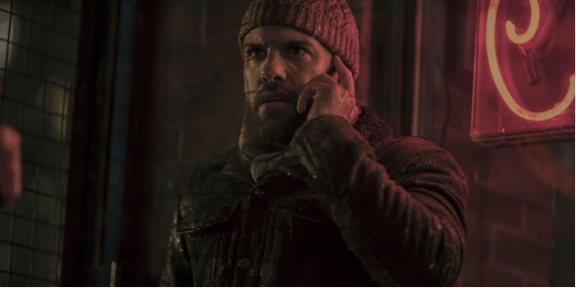 Luke looking concerned as he speaks on the phone