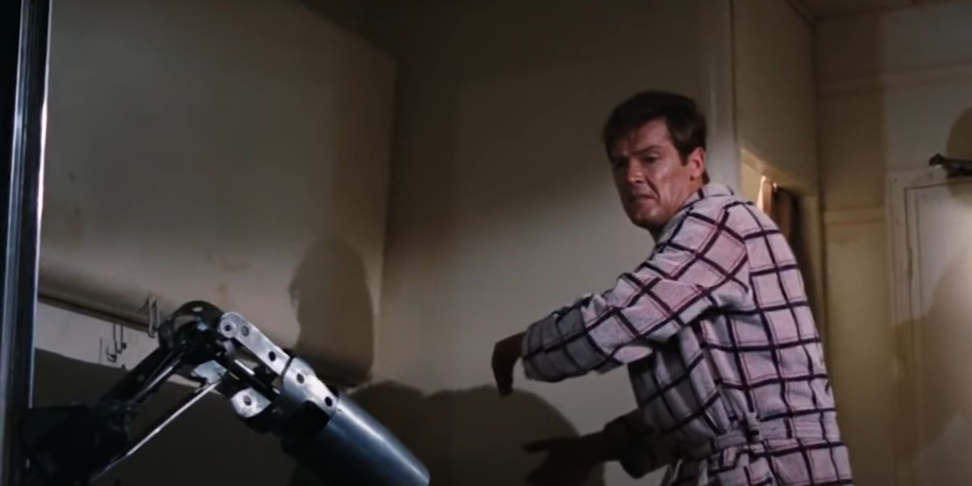 James Bond throws a villain out the window, leaving only his prosthetic arm behind