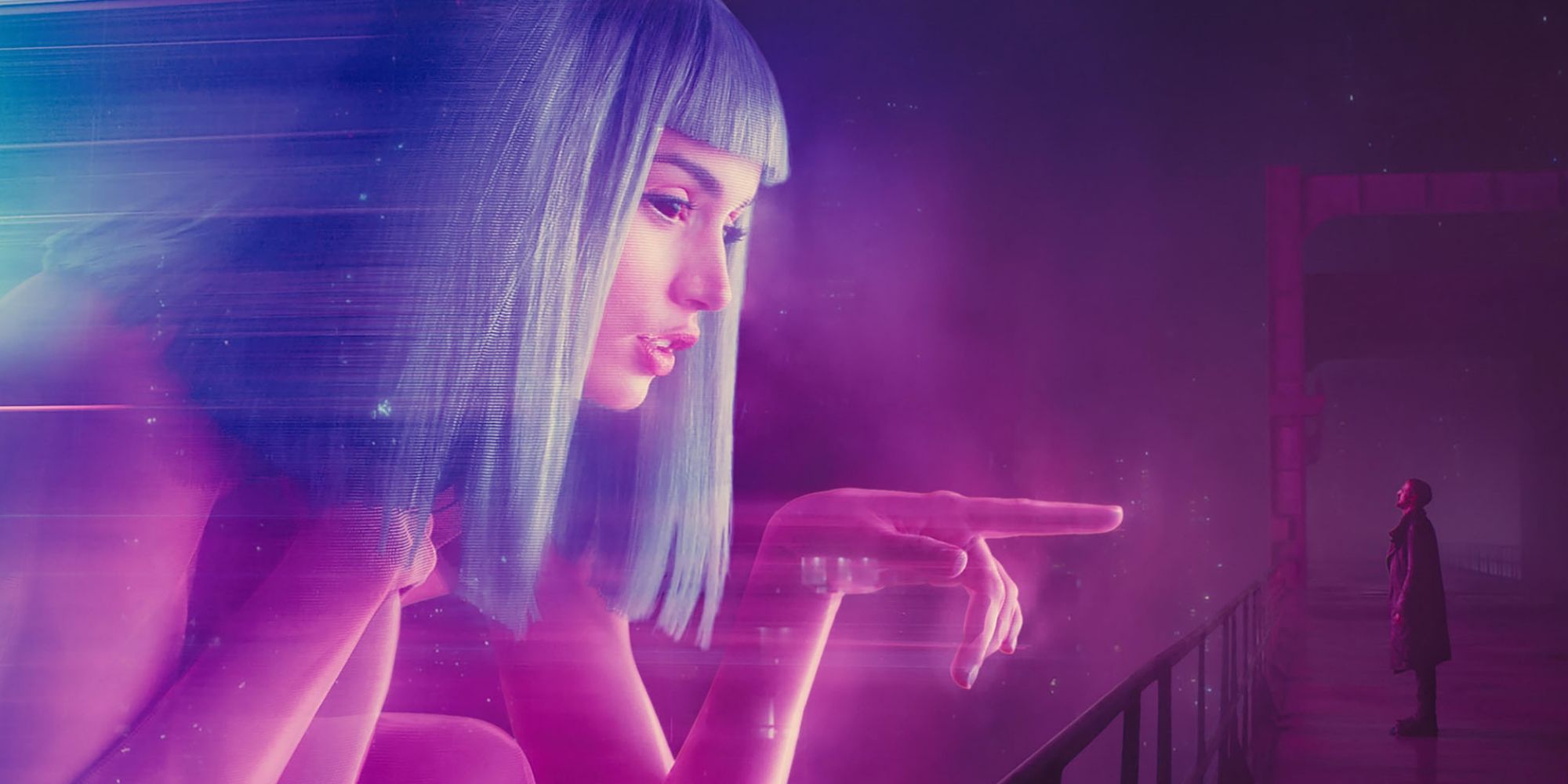 K (Ryan Gosling) standing beneath a hologram of Joi (Ana de Armas) in 'Blade Runner 2049' (2017).