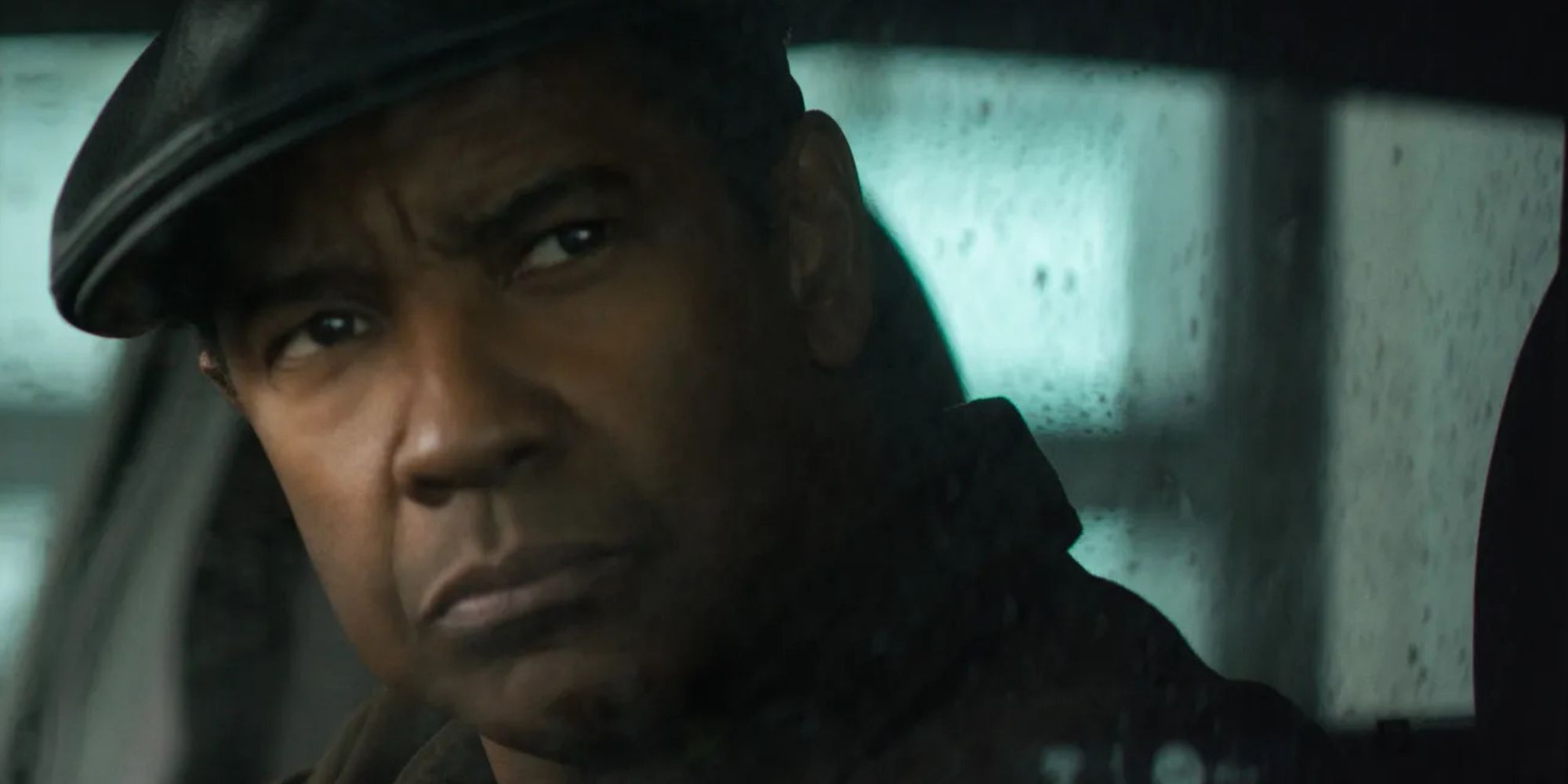 Robert McCall (Denzel Washington) surveys the scene from a car in 'The Equalizer' (2014)