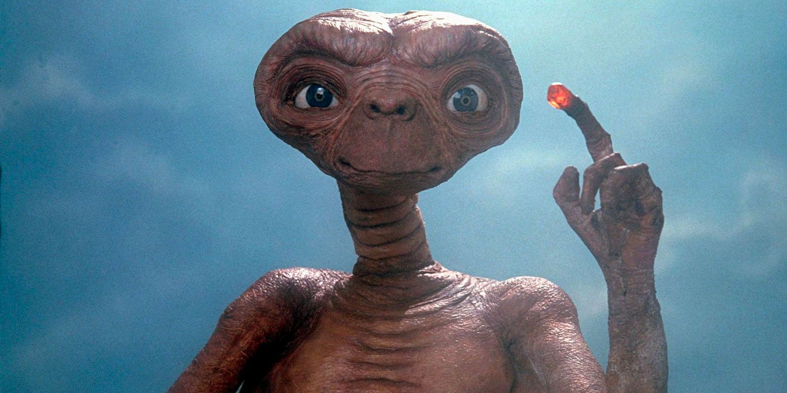 E.T. with a glowing finger looking straight ahead in E.T. the Extra-Terrestrial