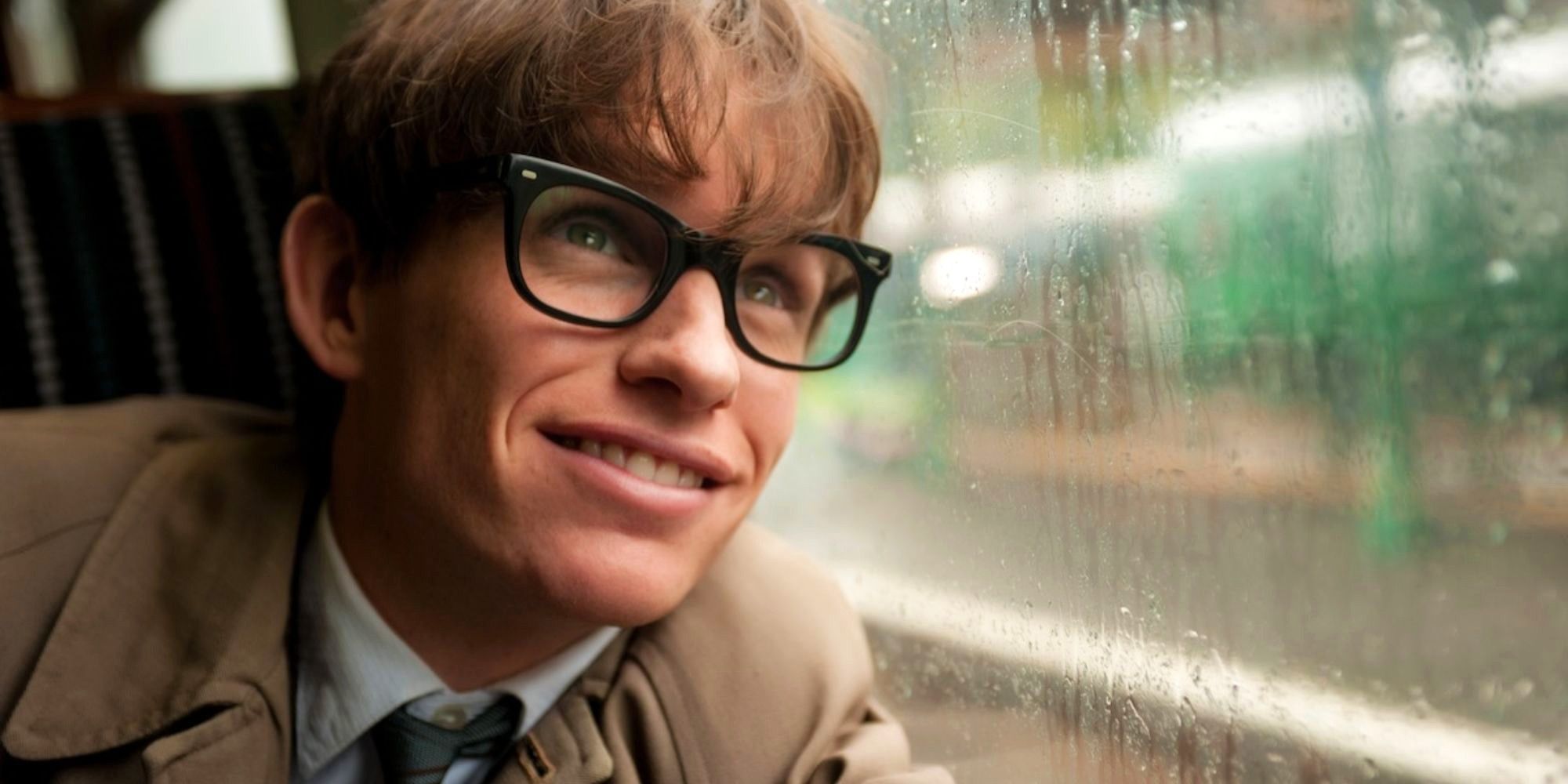 Eddie Redmayne as Stephen Hawking leaning on a window in The Theory of Everything (2014)