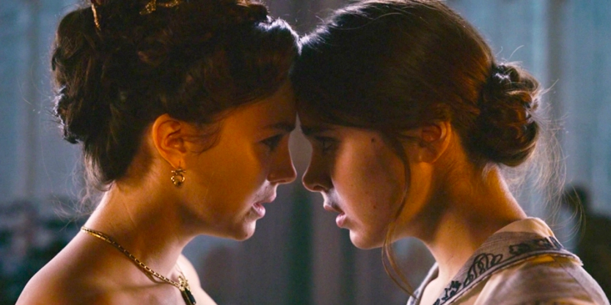 Sue (Ella Hunt) and Emily (Hailee Steinfeld) staring at each other in Dickinson