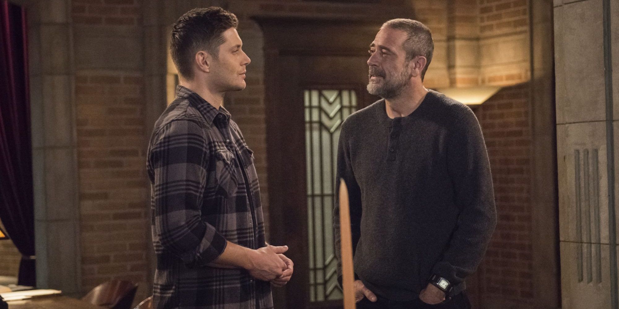 Dean Winchester (Jensen Ackles) stands in the bunker with his father, John (Jeffrey Dean Morgan), in 'Supernatural'.