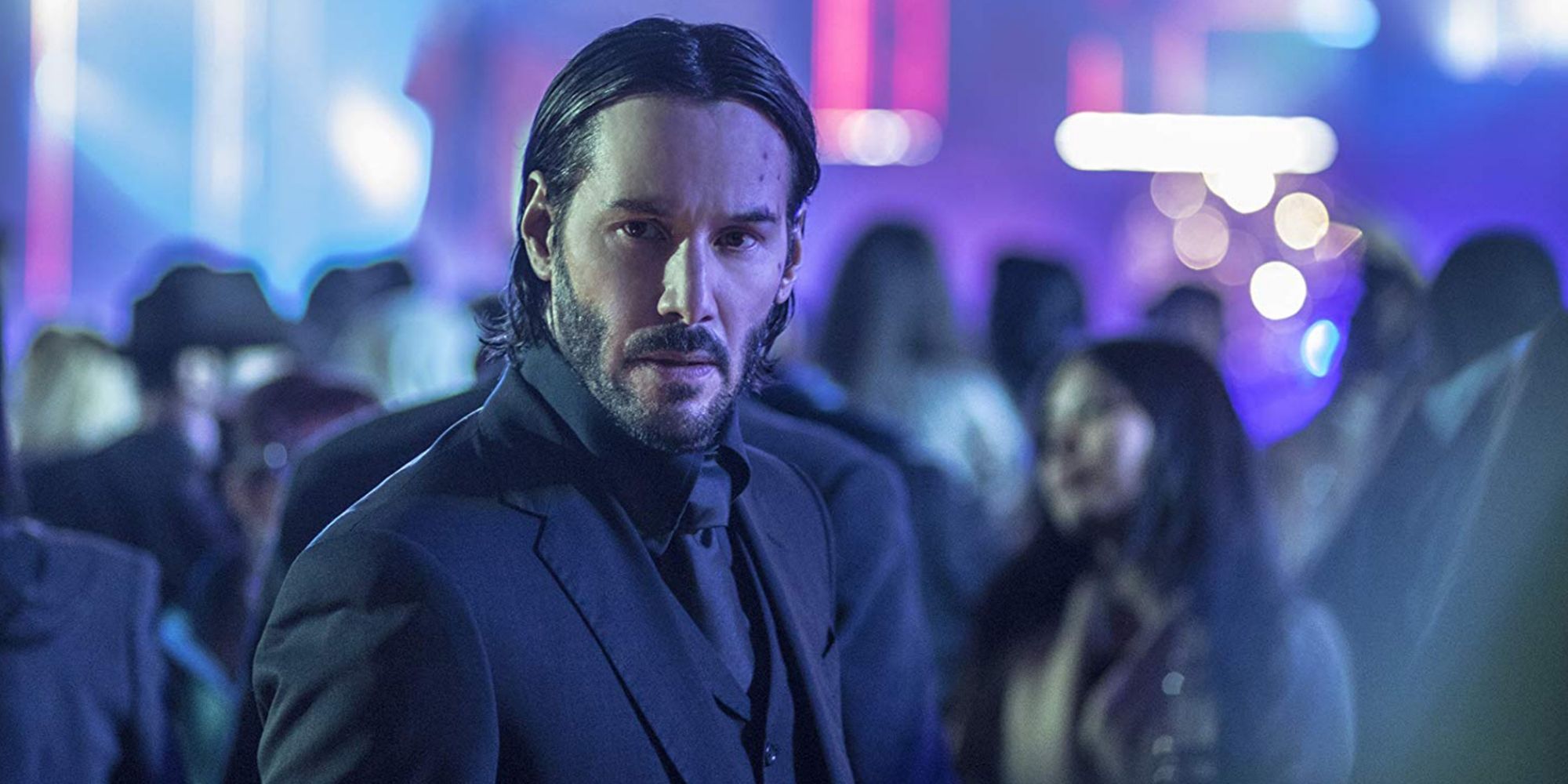 John Wick (Keanu Reeves) standing in a crowd in 'John Wick' (2014)