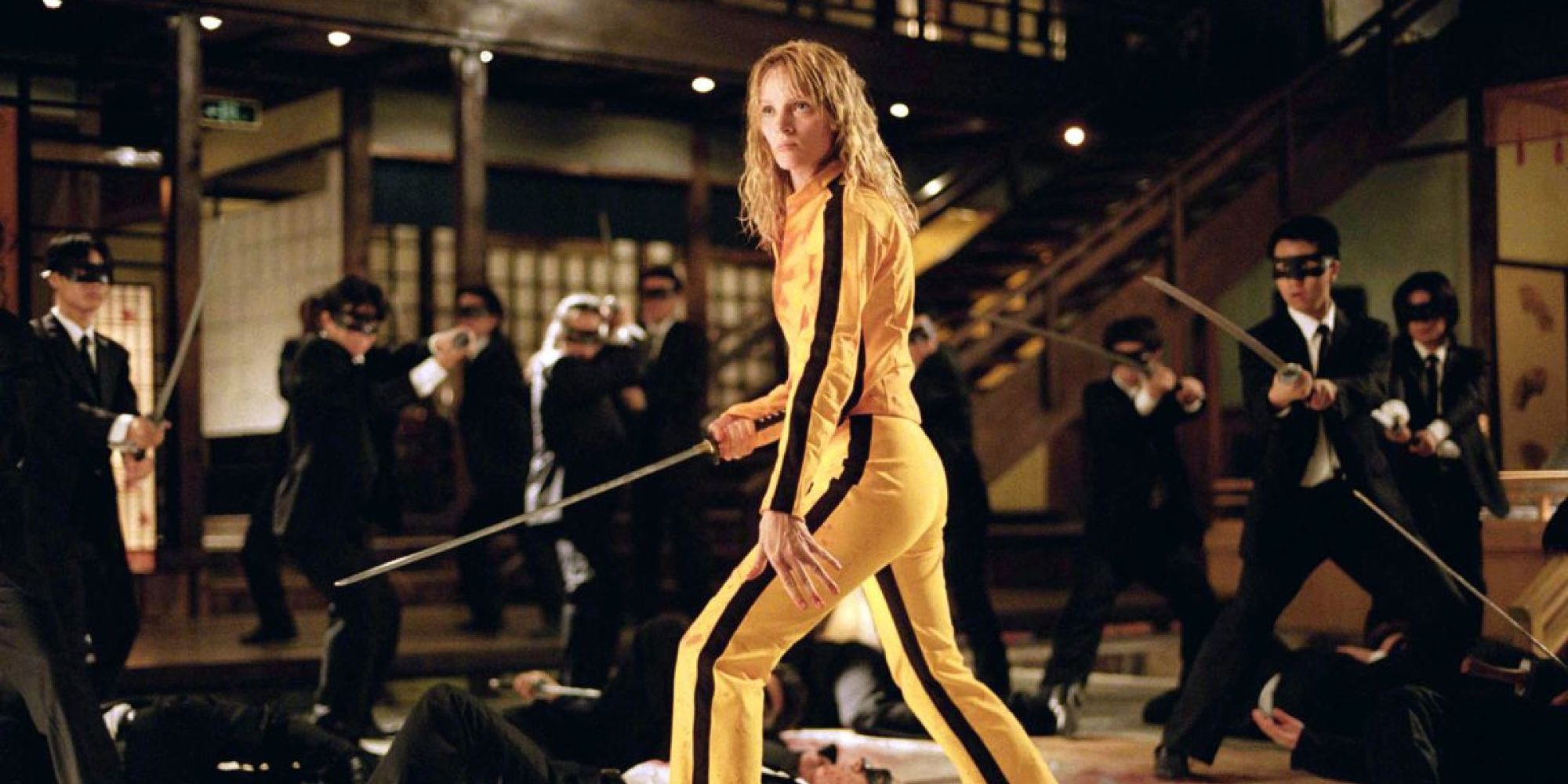 Uma Thurman as The Bride facing off against a group of armed henchmen in Kill Bill Vol. 1