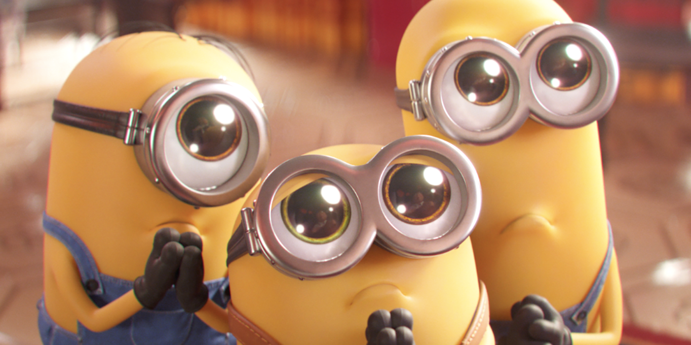 Three minions pleading with their eyes wide in Minions: The Rise of Gru