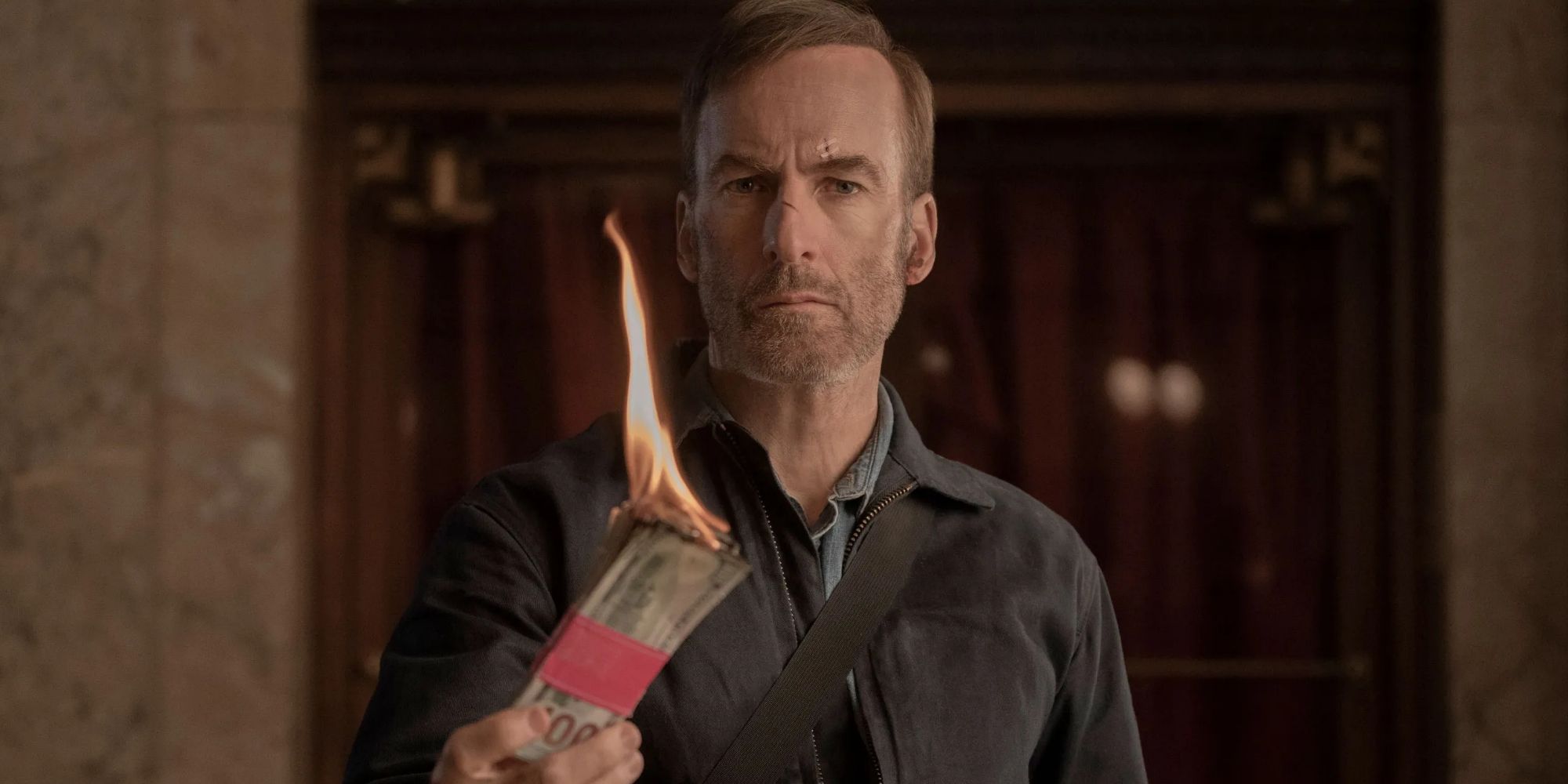 Hutch Mansell (Bob Odenkirk) burns money in 'Nobody' (2021)