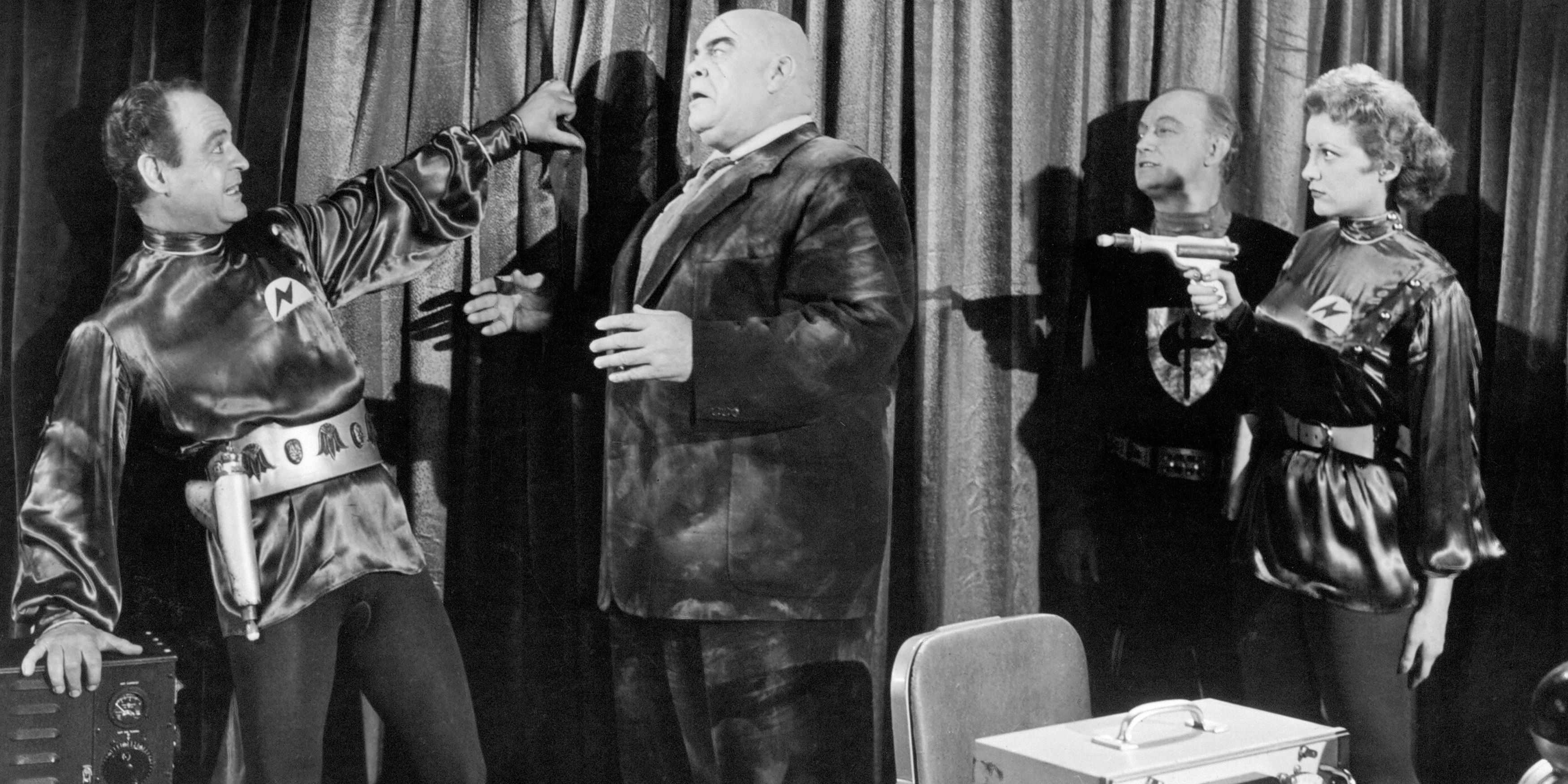 Tor Johnson amid others, with a ray gun being pointed at him, in Plan 9 from Outer Space