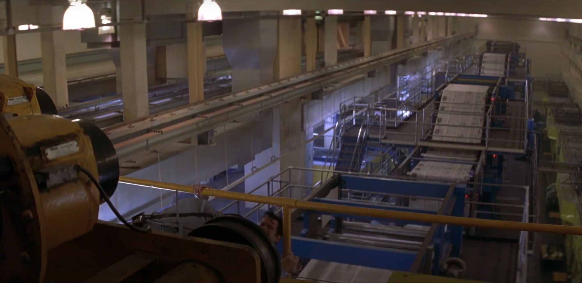 Bond brawls his adversary above a printing press