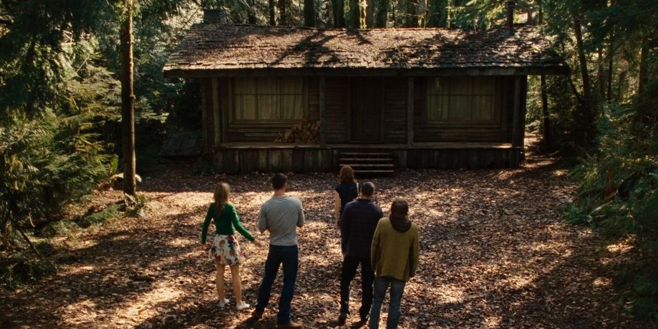 A group of people looking at an old cabin in The Cabin in the Woods