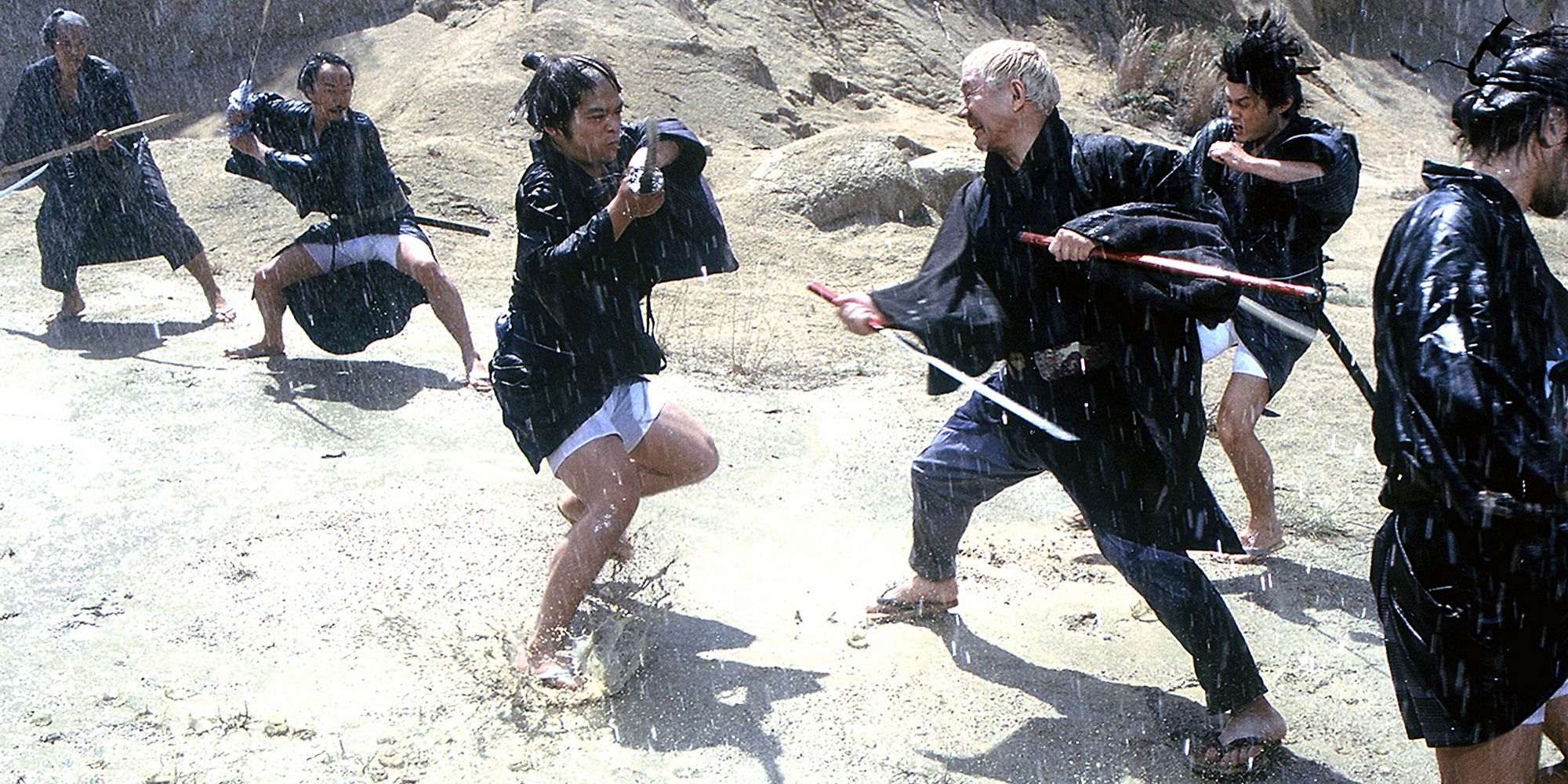 Zatoichi in a swordfight with baddies in Zatoichi