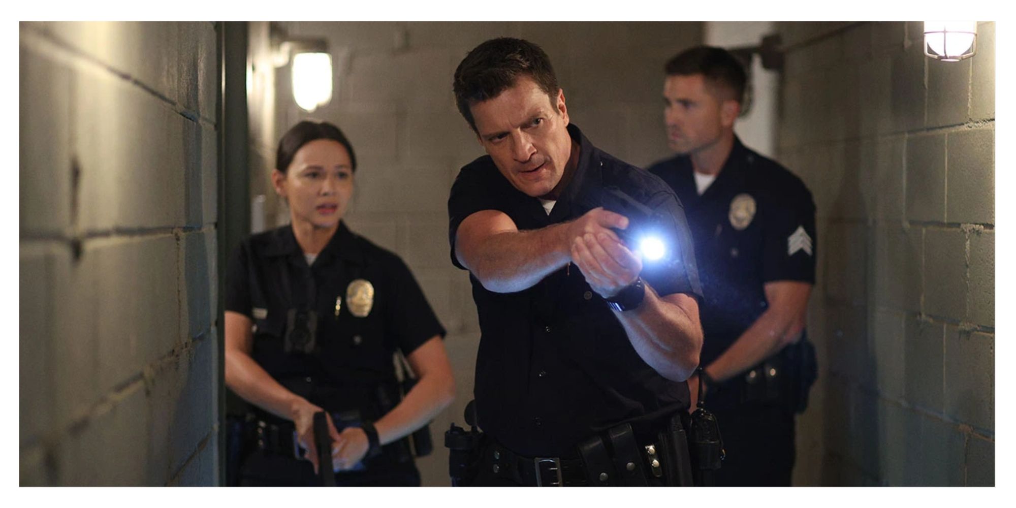 Lucy, Nolan, and Tim in their uniforms in a scene from &lsquo;The Rookie&rsquo;
