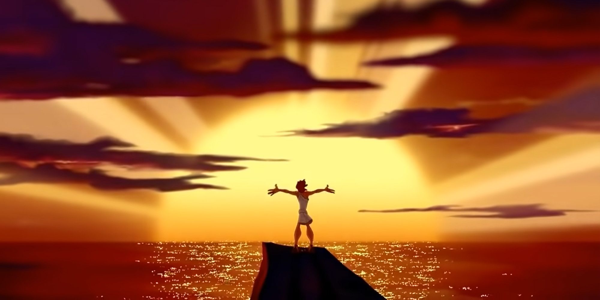 Young Hercules spreading his arms atop a mountian with the sunset in the background in the film Hercules