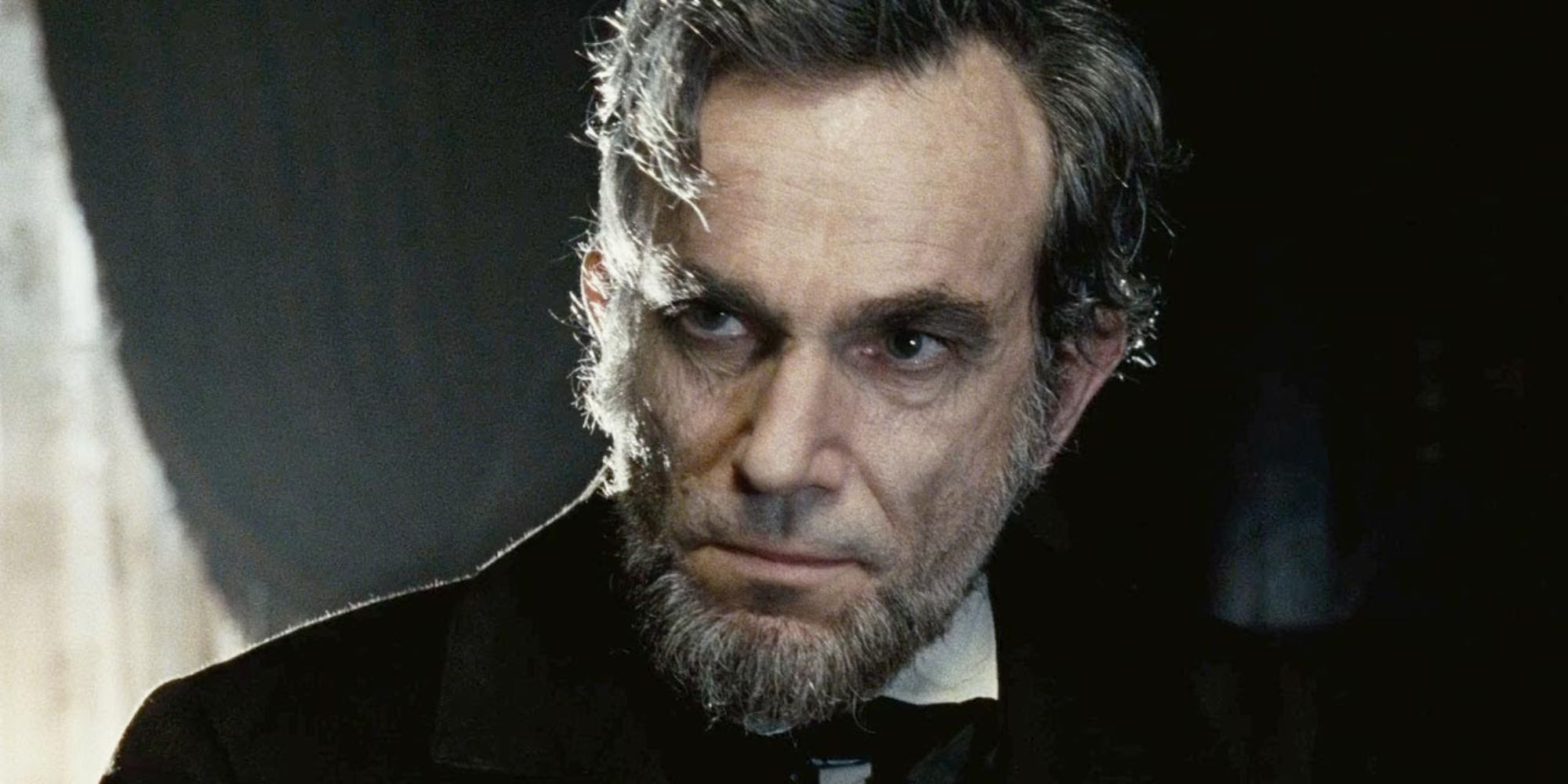 Daniel Day-Lewis as Abraham Lincoln looking intently at something off-camera in Lincoln.