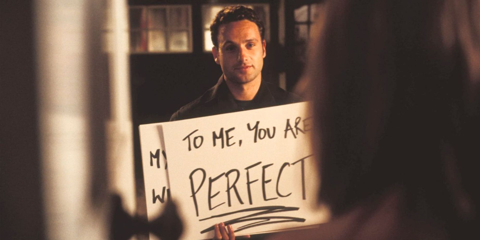 Mark from Love Actually showing the cardboard posters to Juliet