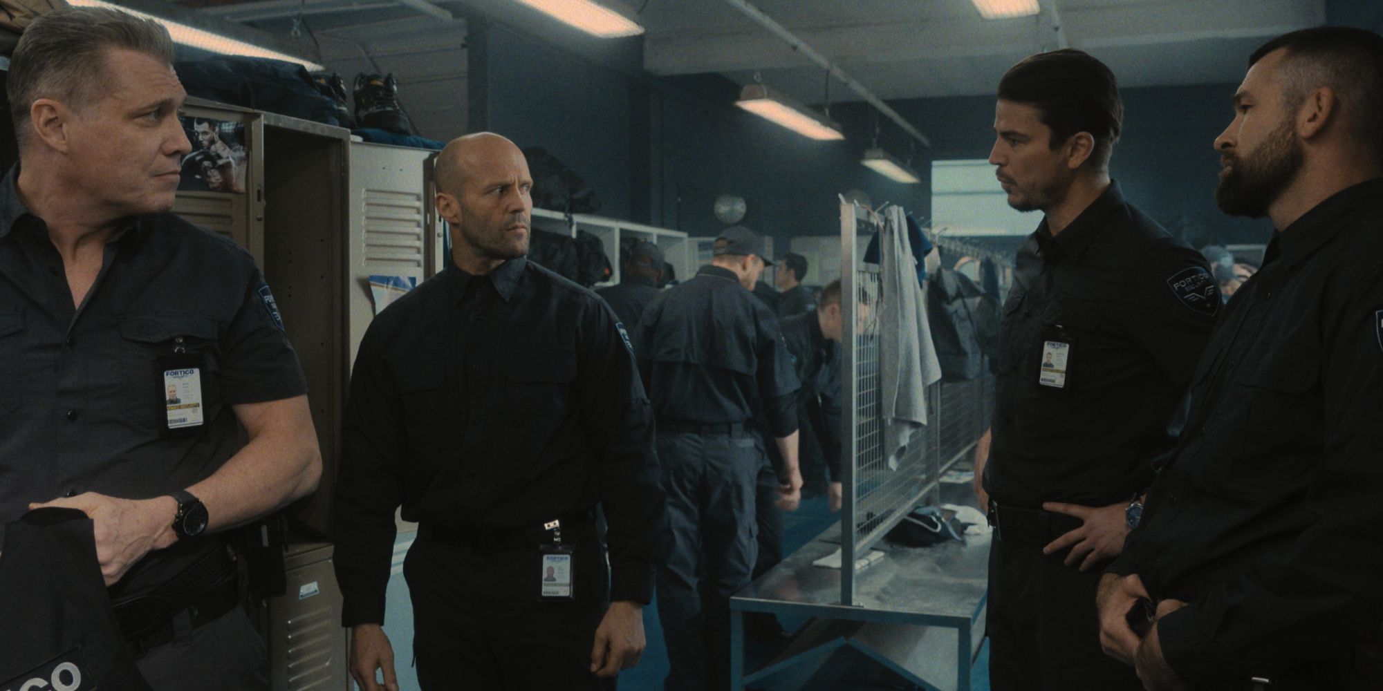 4 hostile men are confronting each other in a locker room