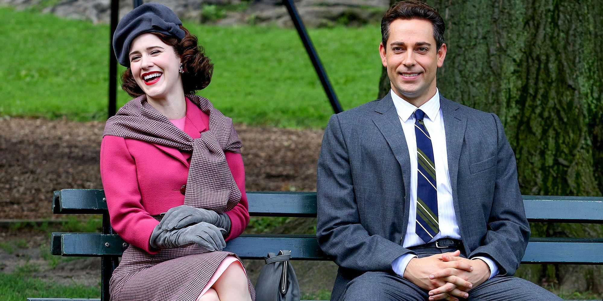 Midge and Joel from The Marvelous Mrs. Maisel sitting on a park bench together