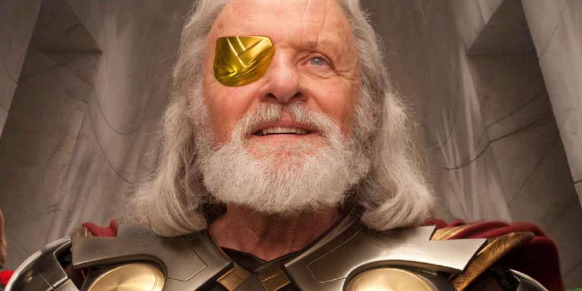 Sir Anthony Hopkins as Odin with an eyepatch, smiling. 