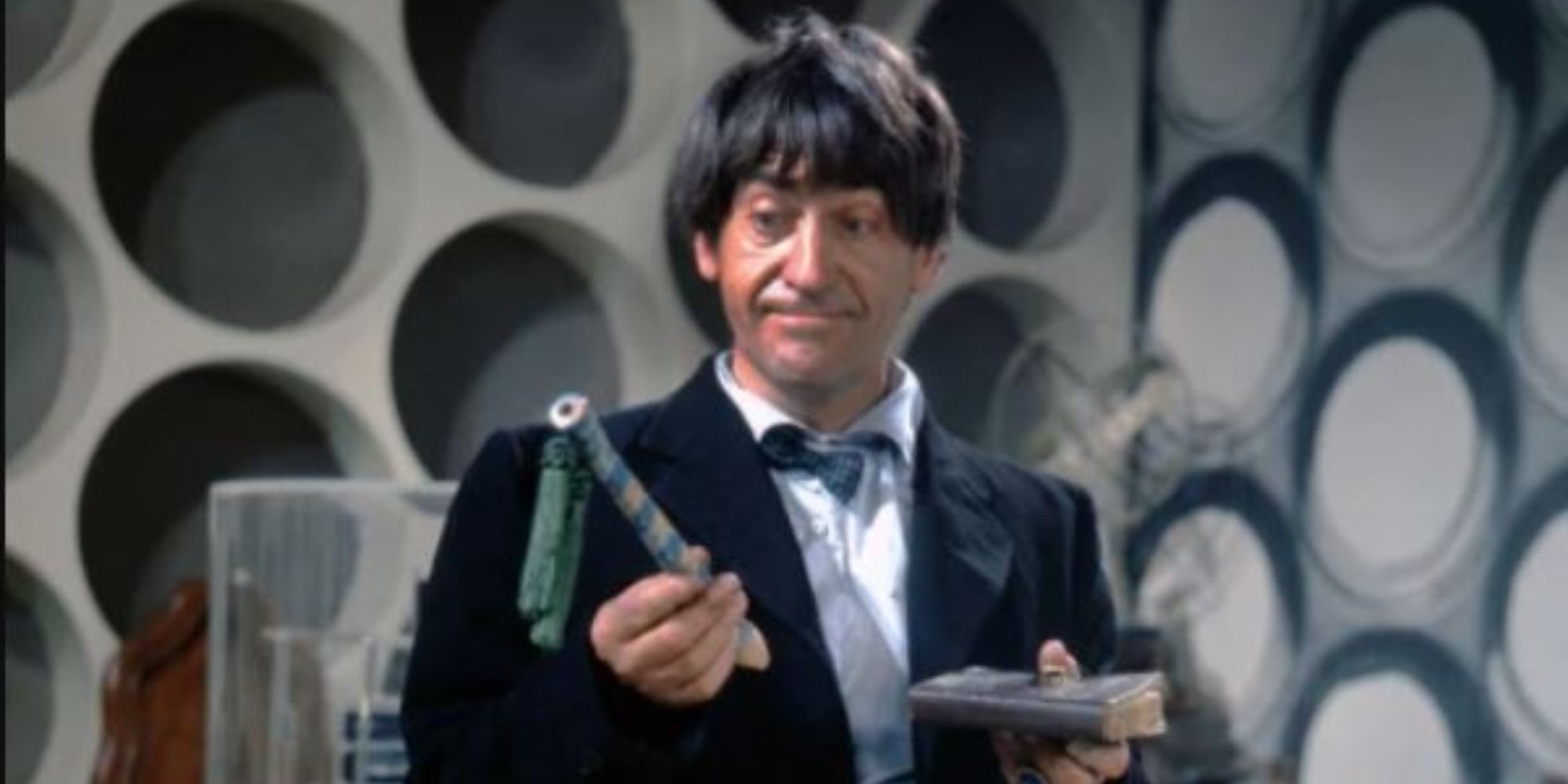 2nd Doctor in the TARDIS holding his diary and a recorder