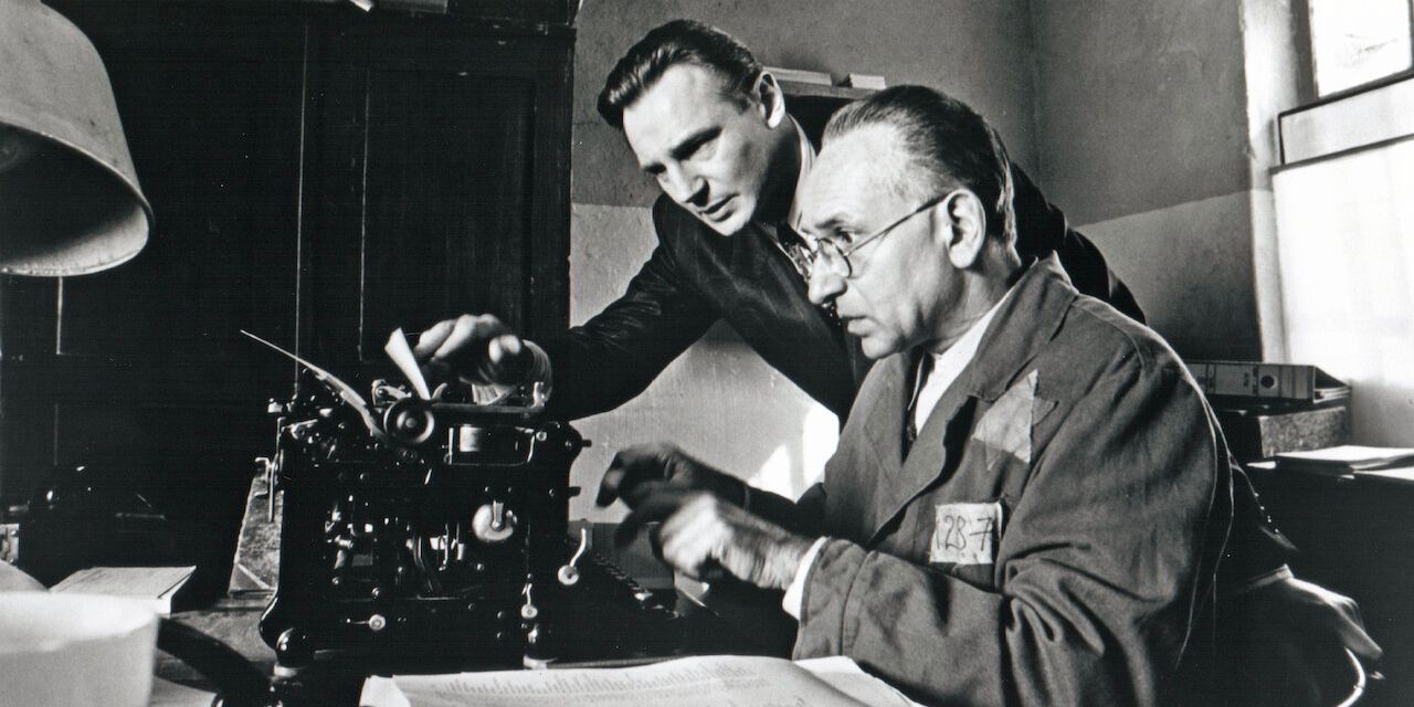 Liam Neeson and Ben Kingsley in 'Schindler's List', standing in front of a typewriter