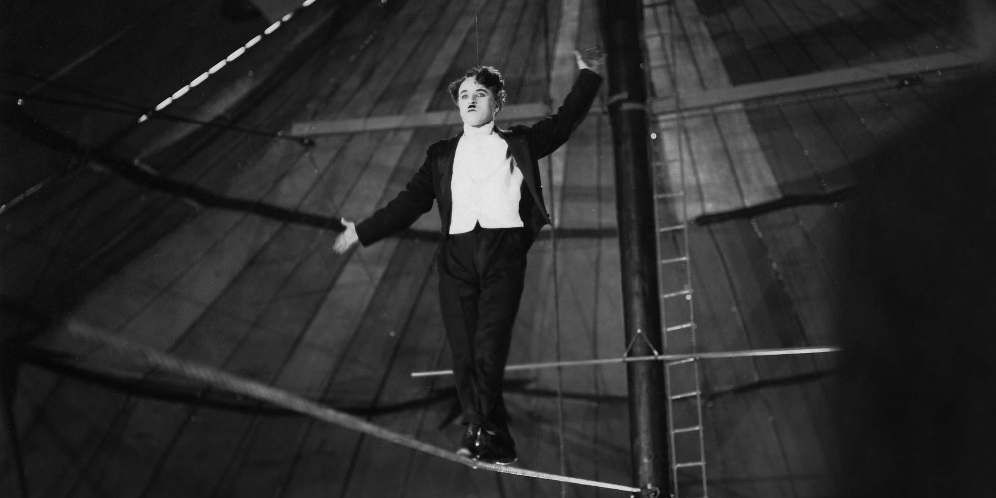 The Tramp walking the tightrope in a circus