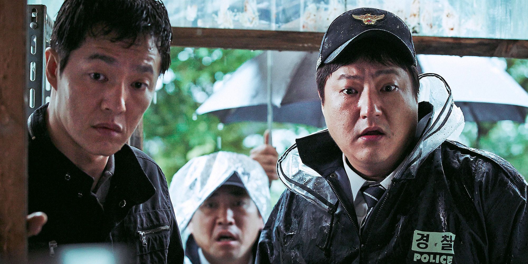 Kwak Do-won and Jo Han-chul standing with shocked looks on their faces in The Wailing