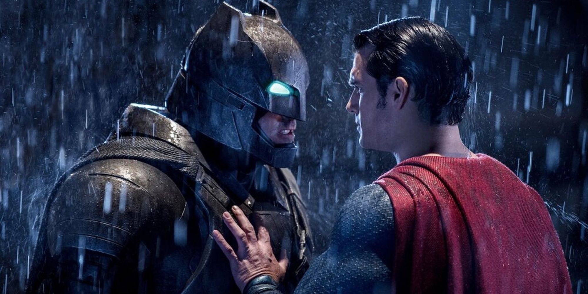 Armored Batman confronting Superman in the rain